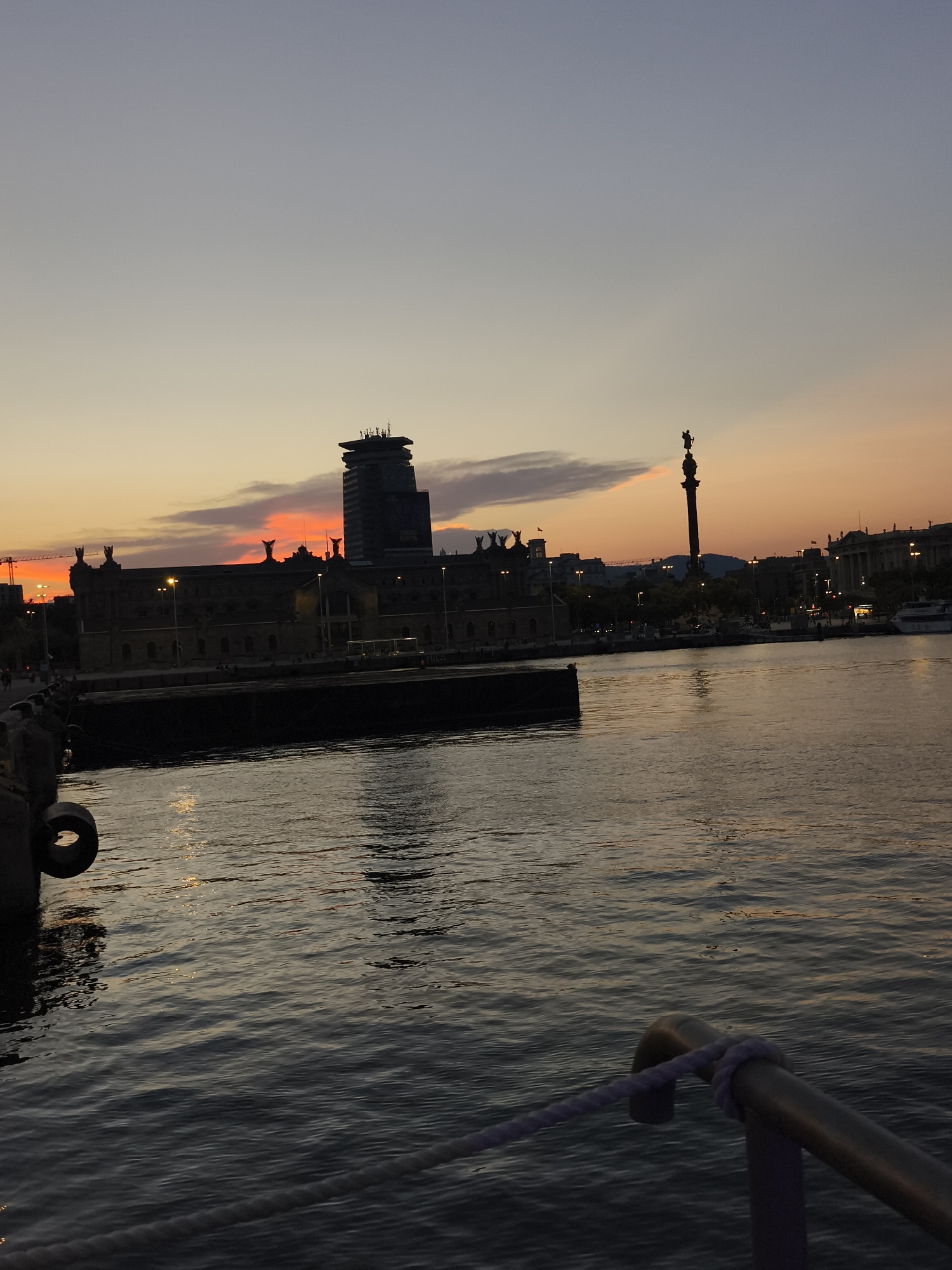 Live music and sailboats at Barcelona's waterfront at dusk