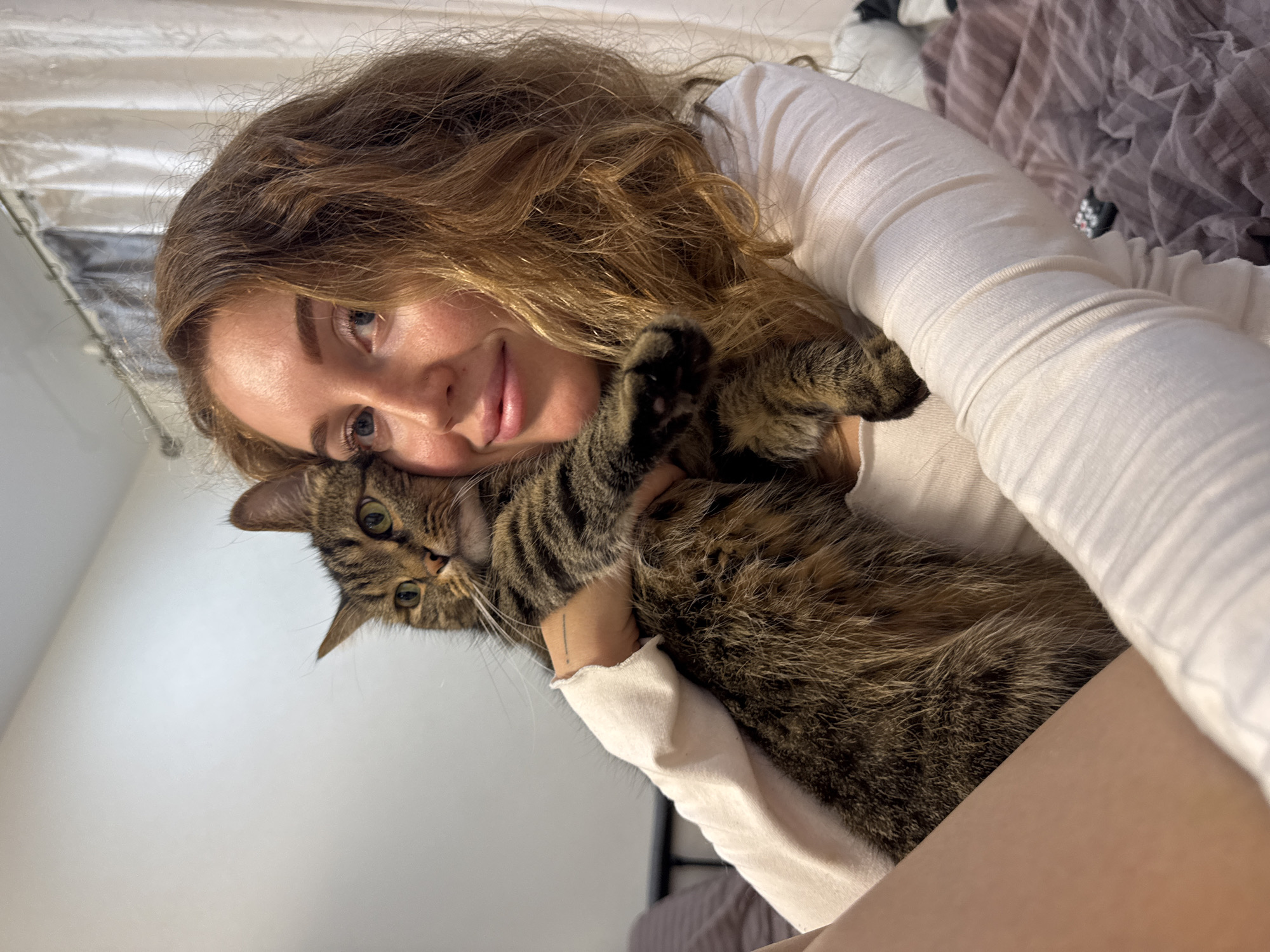 Woman poses with cat and dog in Chaikovsky home