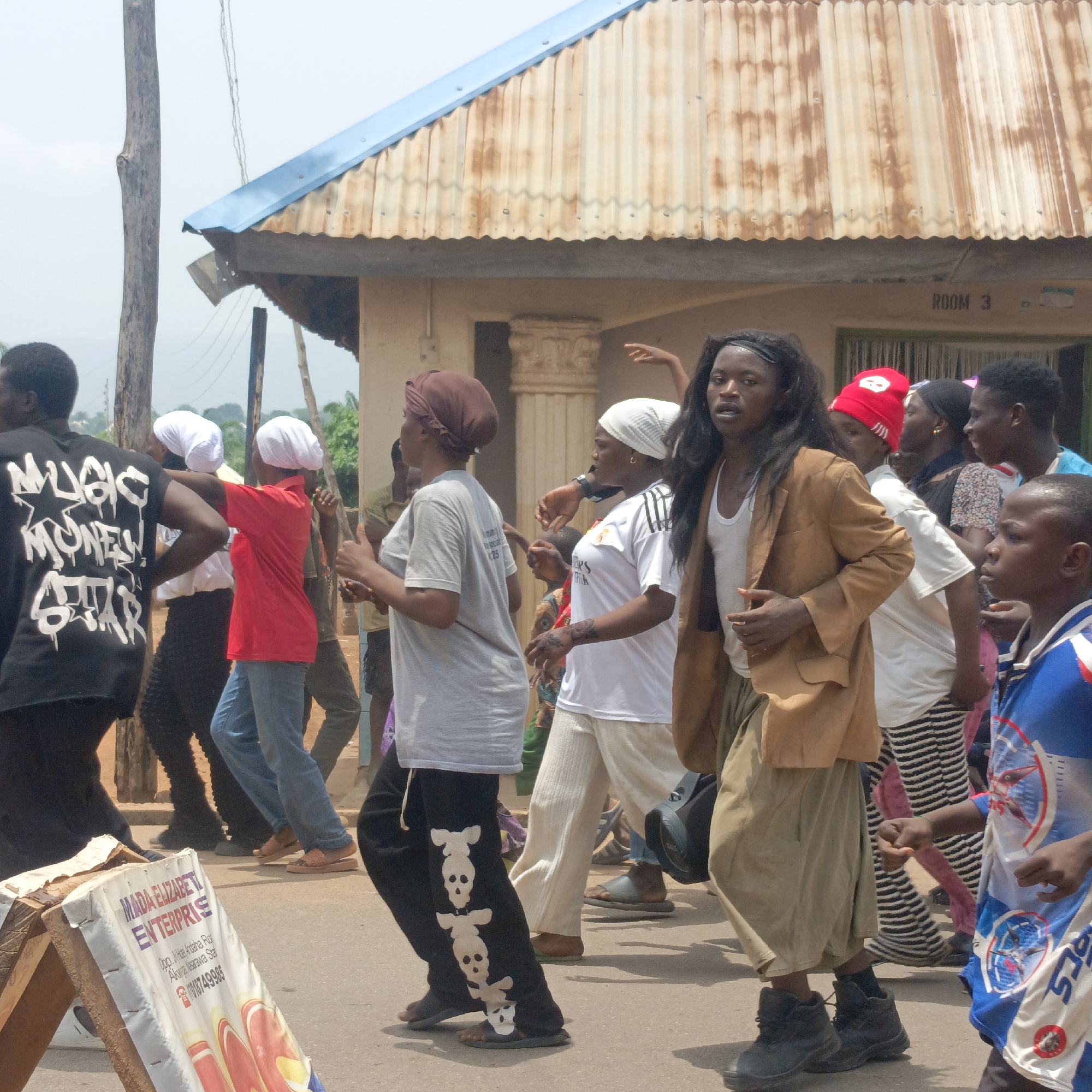 Traditional costumed figure walks through Akwanga, Nigeria streets