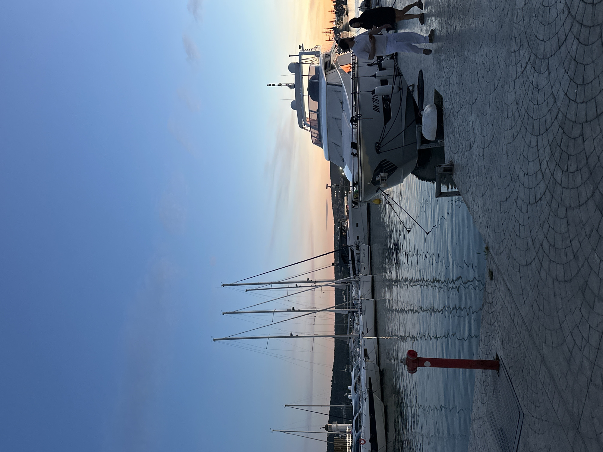 Luxury cars gather at Varna marina during sunset