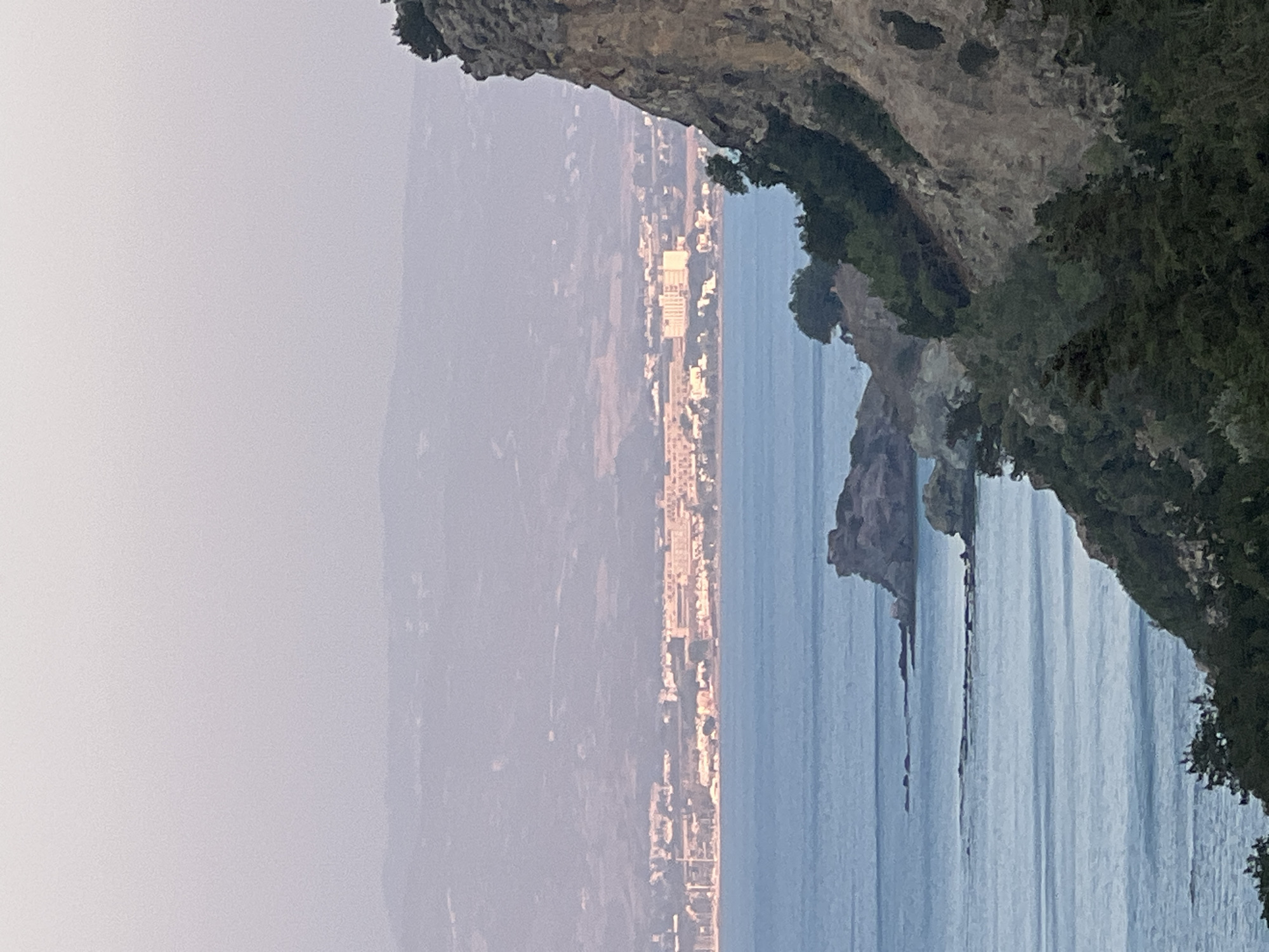 Rocky cliffs and calm sea at dusk, Neo Chorio, Cyprus