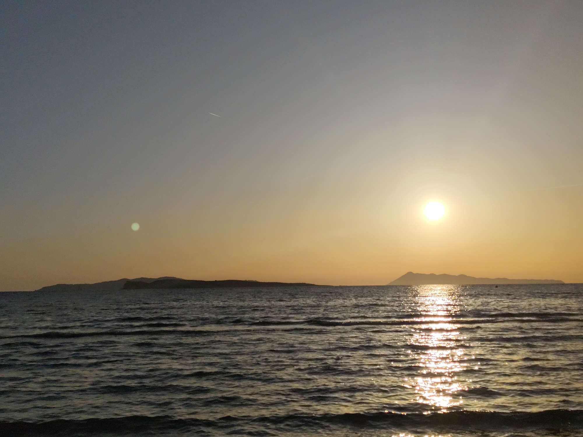 Coastal sunset and beach activities documented by witnesses