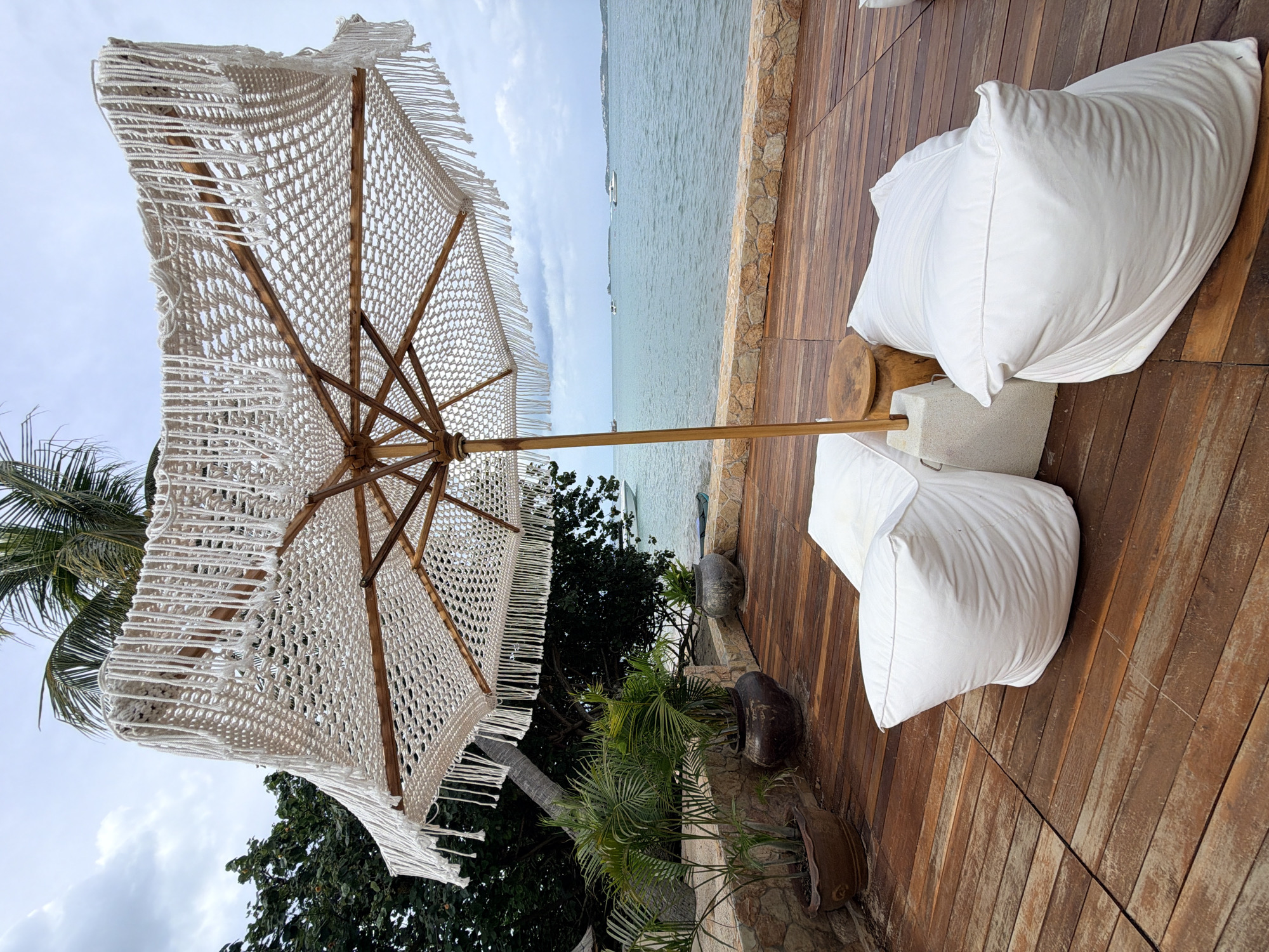 Laid-back Ko Samui beach setup with boats, loungers, and tropical pavilions