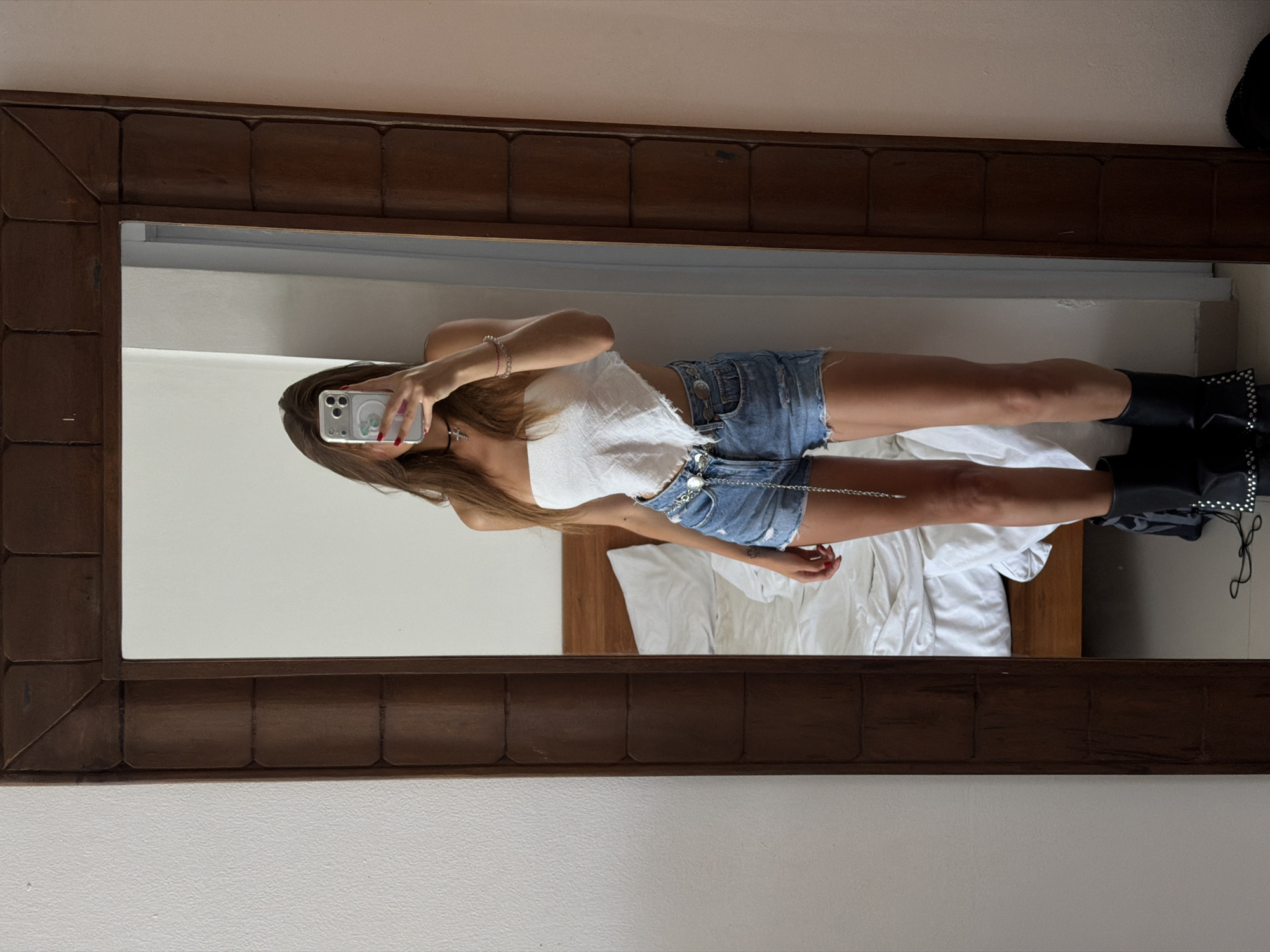 Person takes mirror selfie in North Kuta room