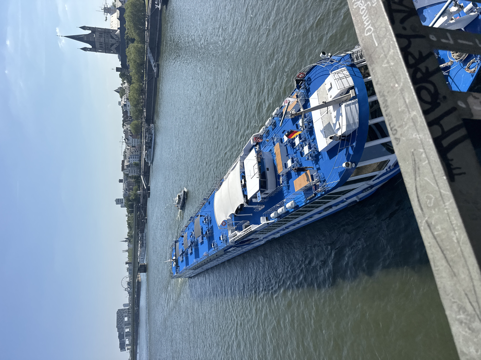 Rhine riverfront scenes: cruise ship, love locks, Cologne skyline