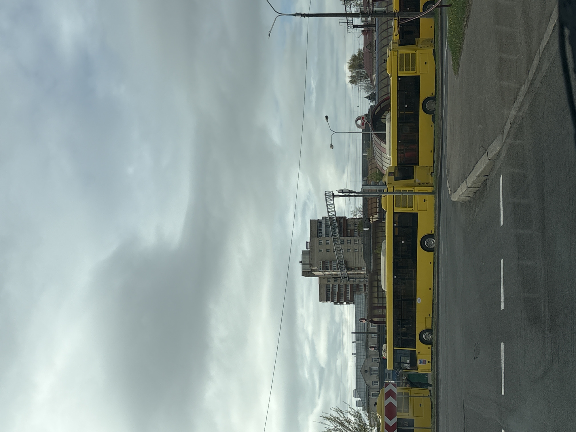 Morning street scene captured with woman in car, buses in Minsk