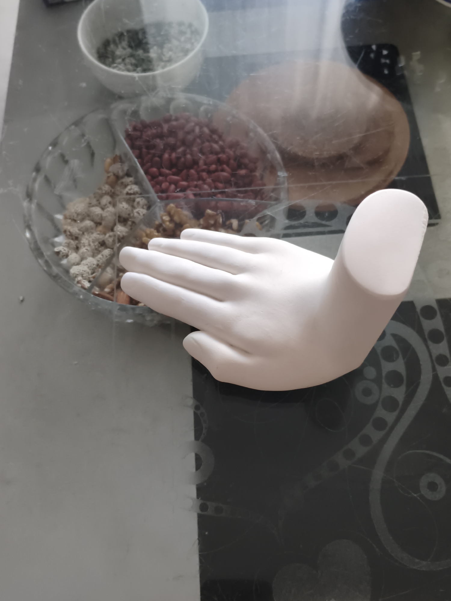 Tabby cat investigates a candy bowl display at home