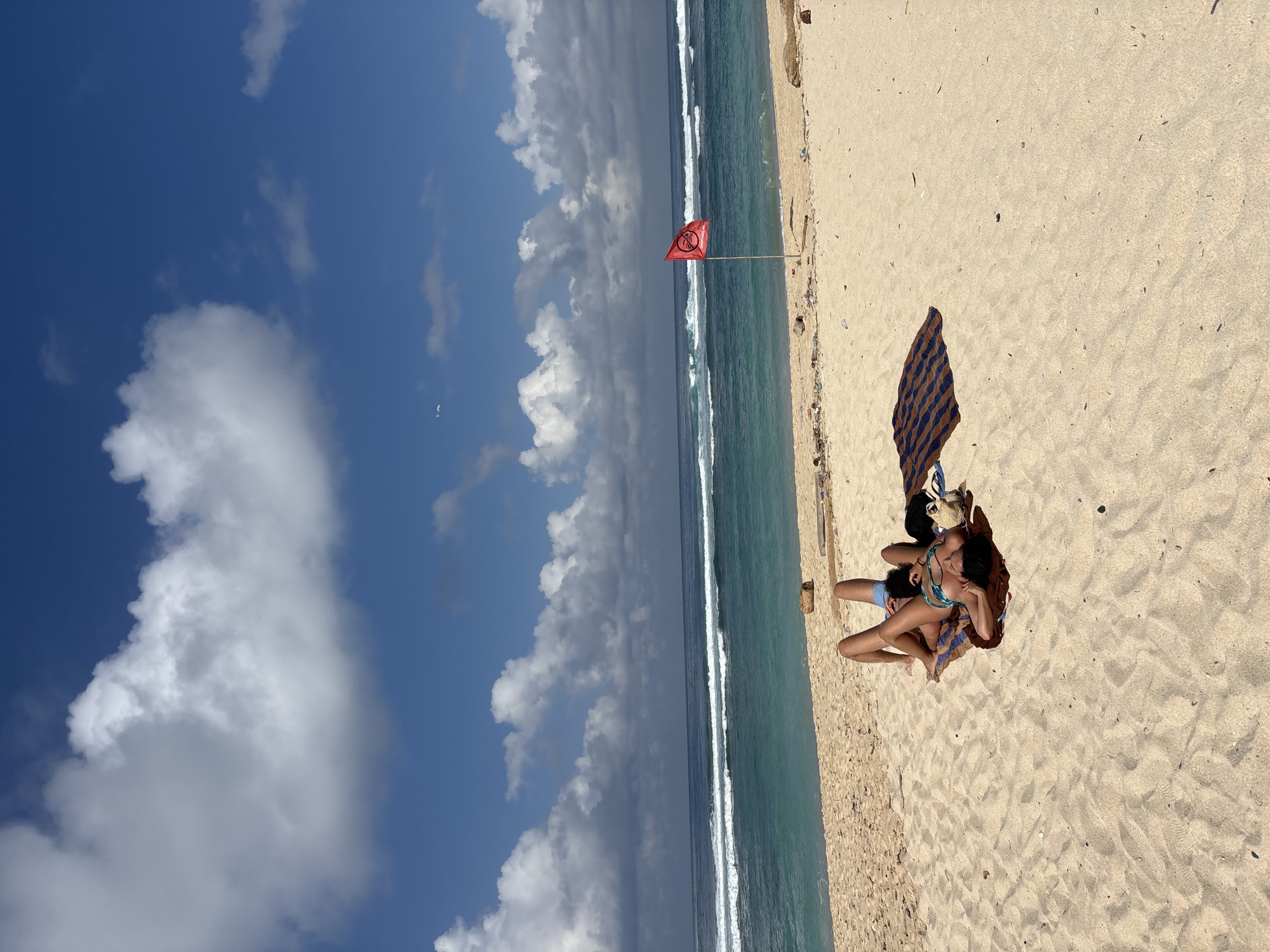 Tourist captures scenic Kuta Selatan beachfront during sunny afternoon
