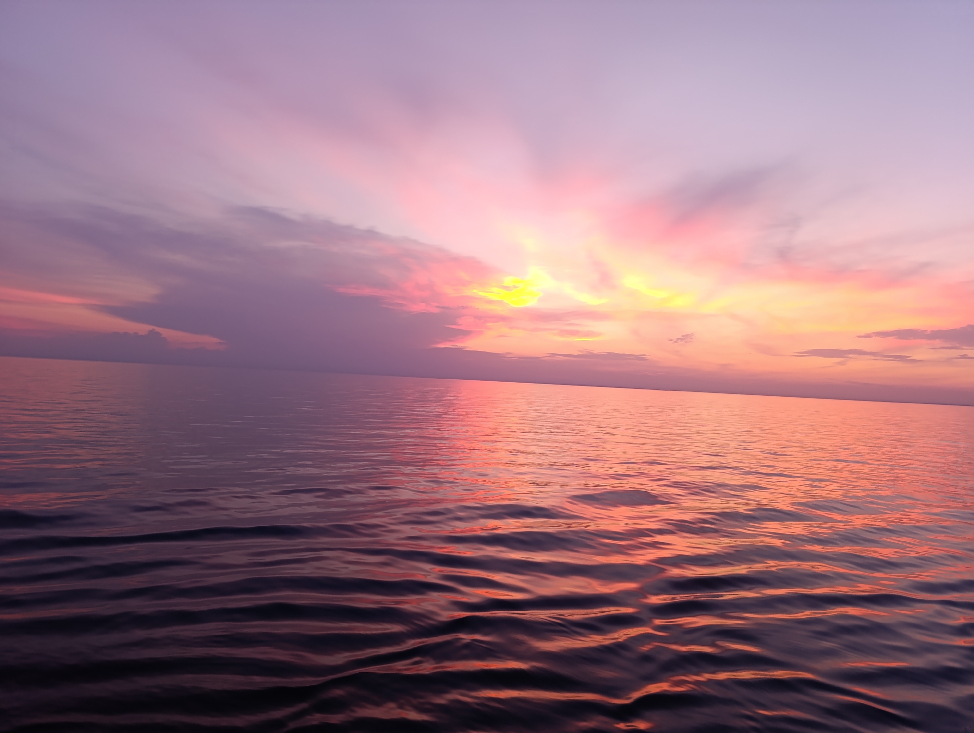 Sunset colors spreading across a calm stretch of water