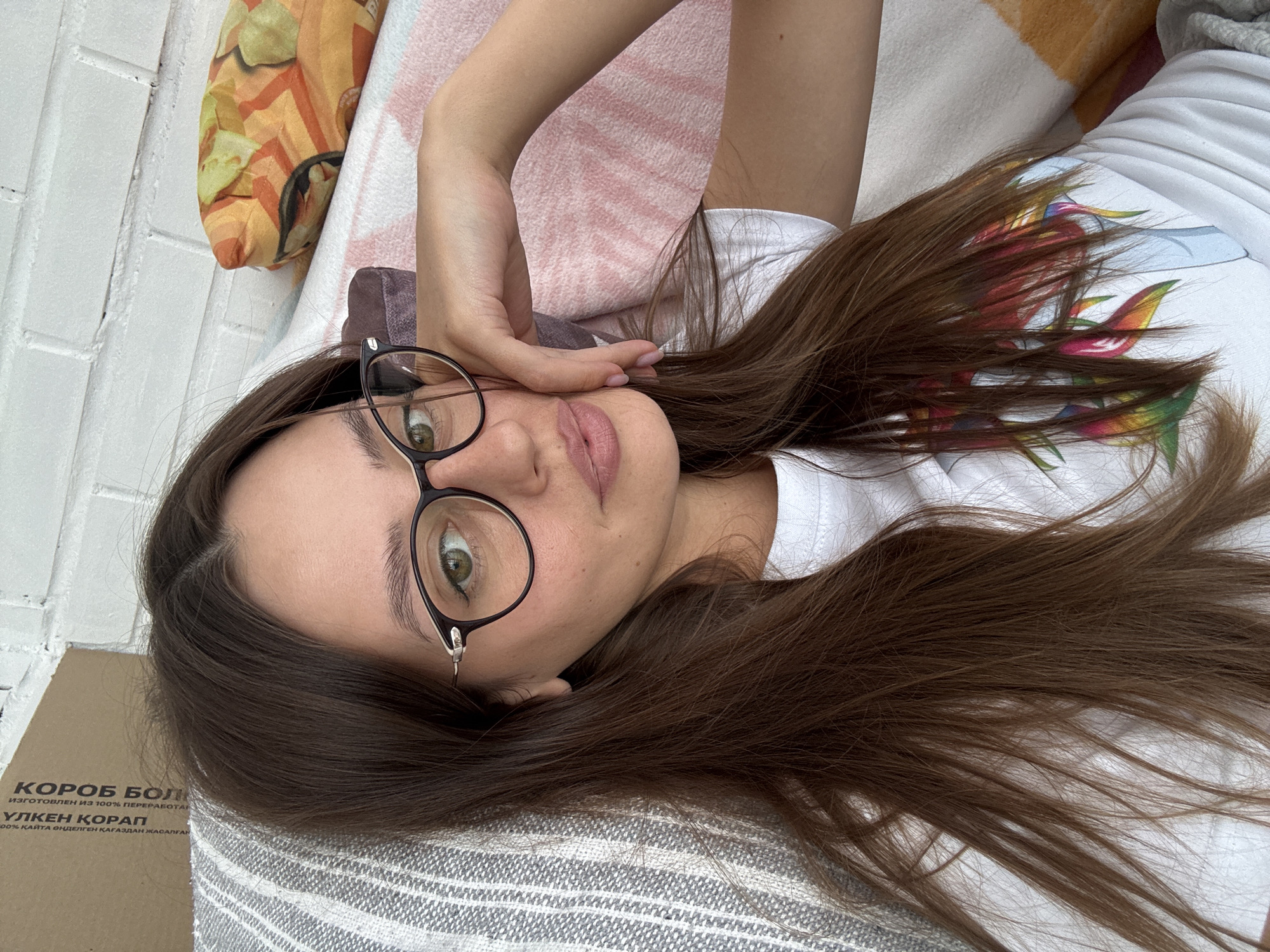 Woman photographed with pet cockatiel, artwork in Krasnoyarsk