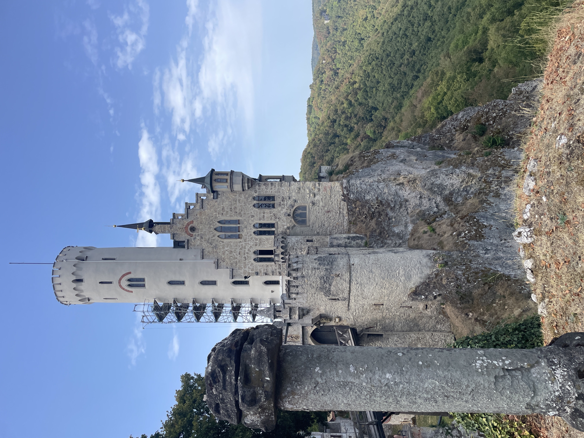 Castle on a cliff and a red-roofed valley town