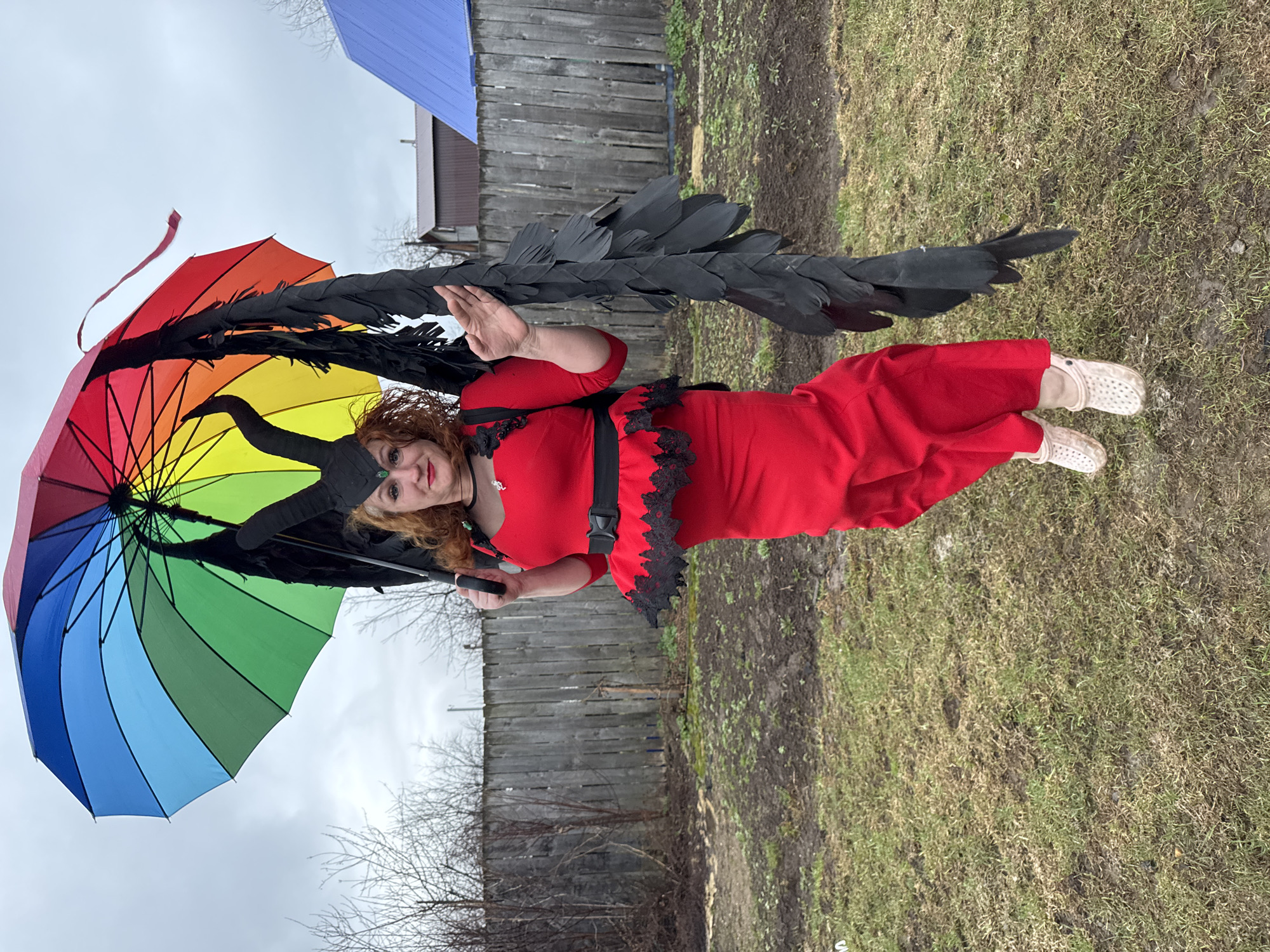 Costumed woman poses with rainbow umbrella in Chaikovsky, Russia