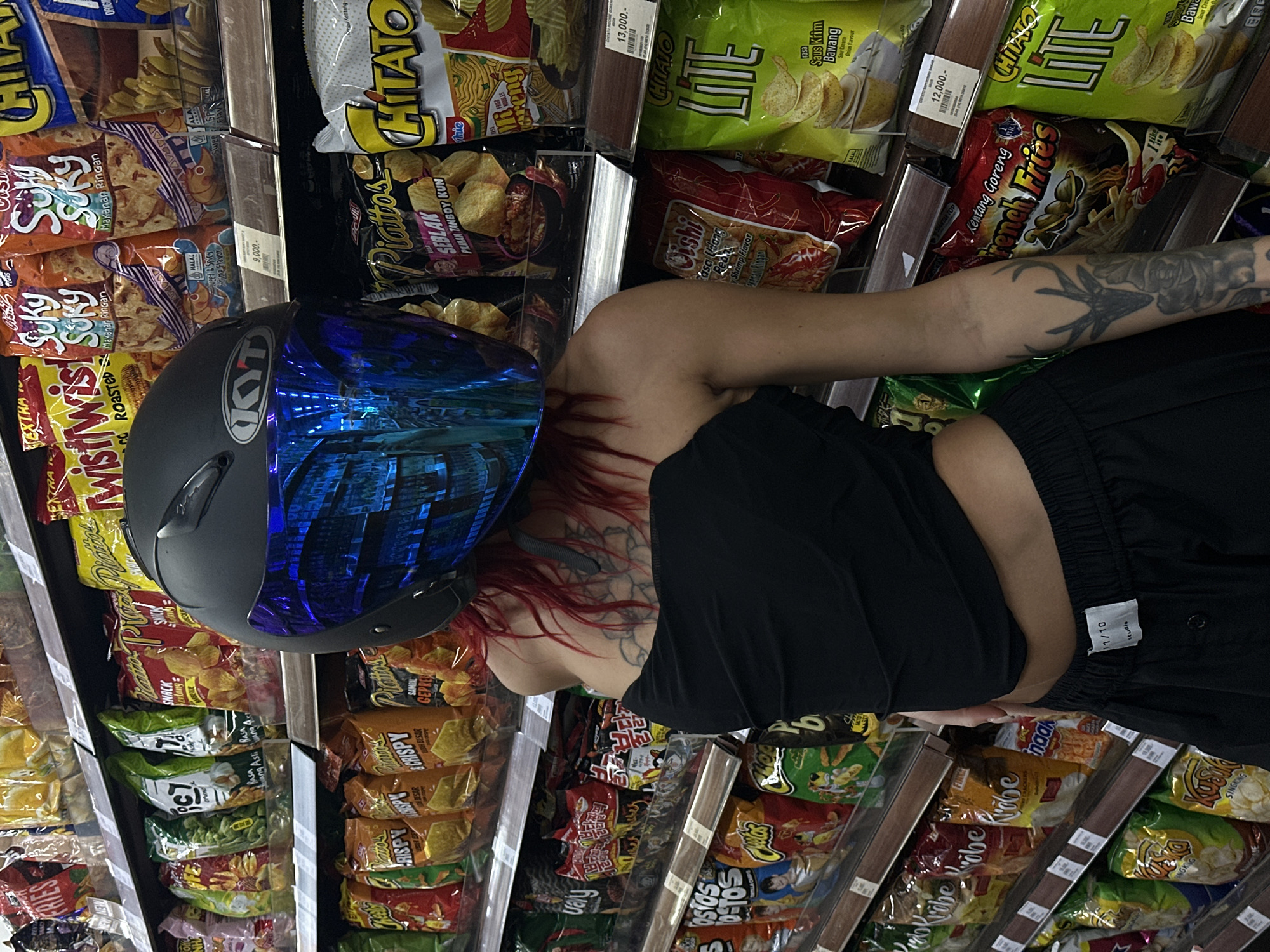 Woman shops for snacks in North Kuta grocery store