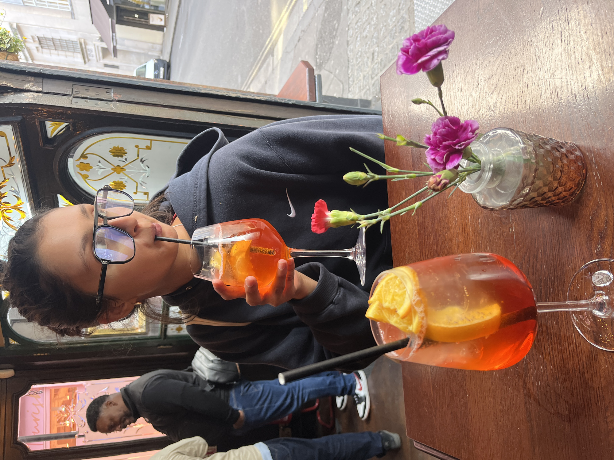 Person sits at table in London cafe during daytime