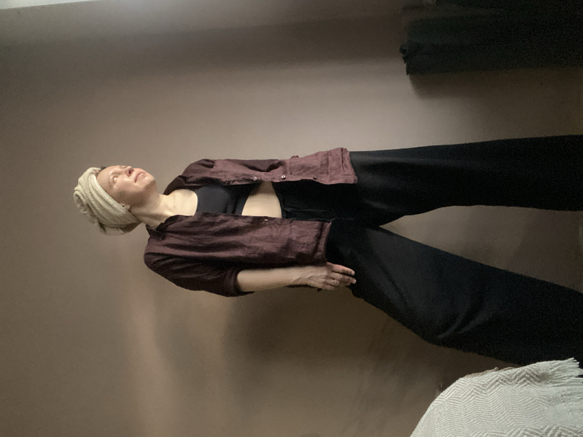 Woman photographs herself in residential setting in Chaikovsky, Russia