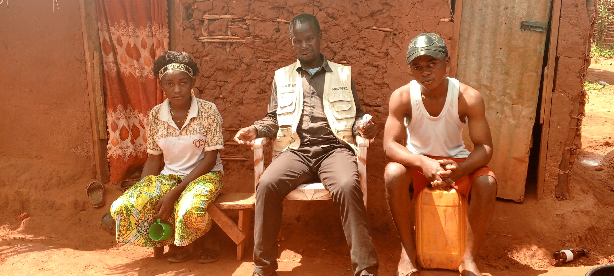 Residents gather outside traditional homes in rural DR Congo