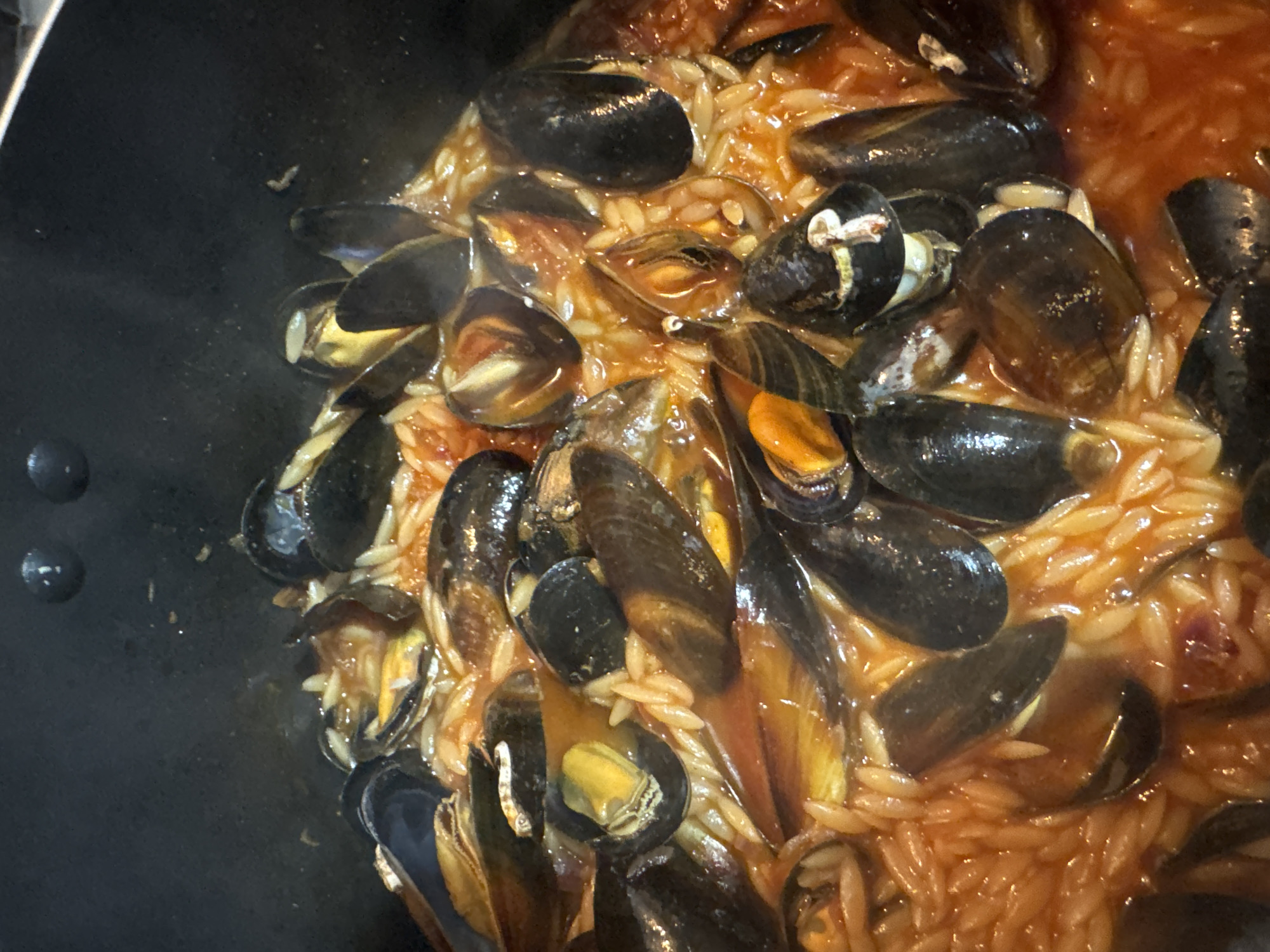 Home cooking: mussel pasta preparation in Desborough evening