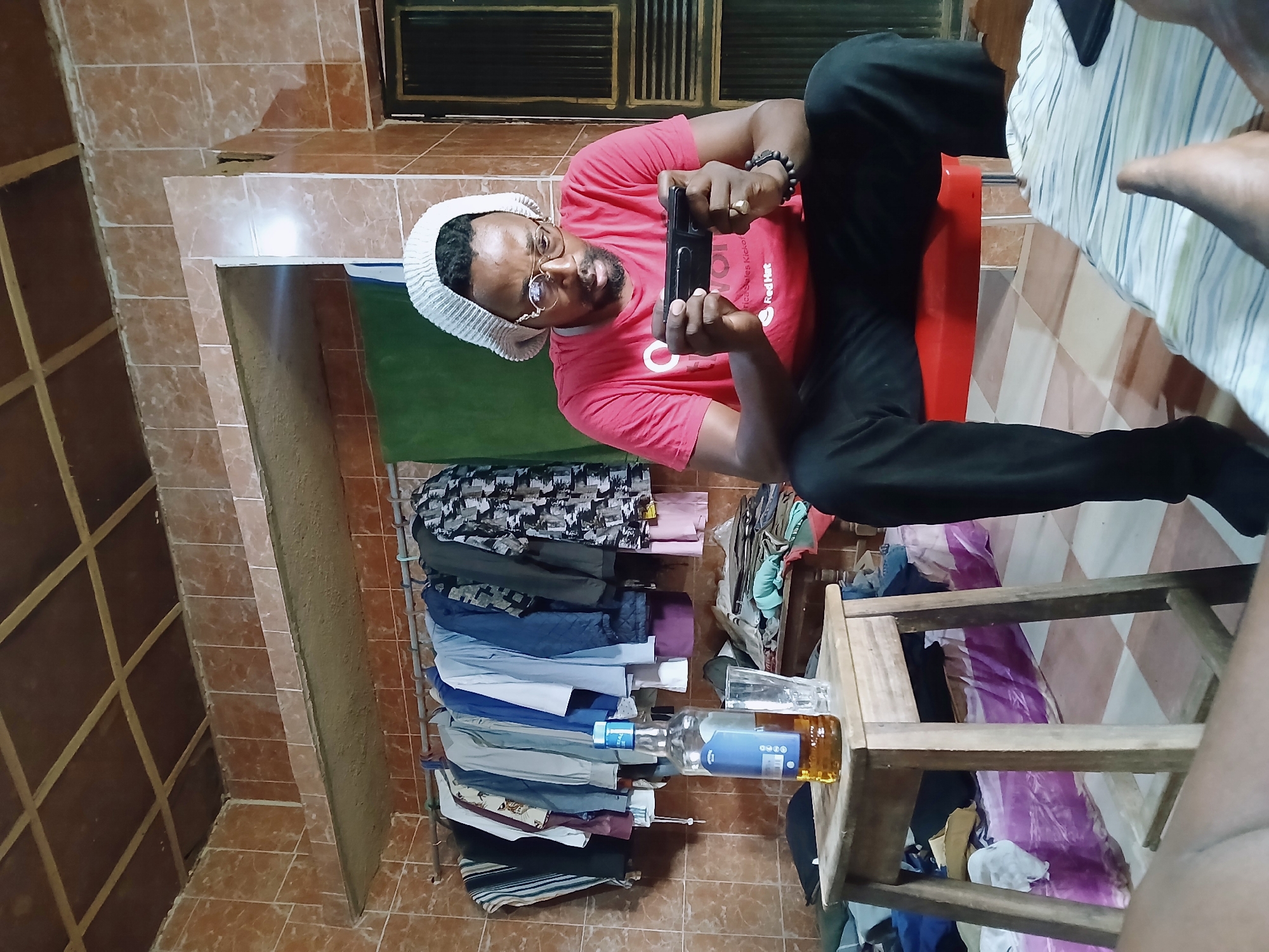 Men using phones in casual settings observed in Kitwe