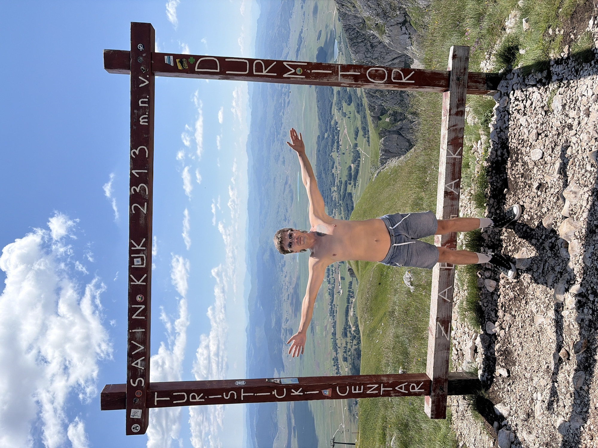 Arms wide at the summit of Savin Kuk, Durmitor