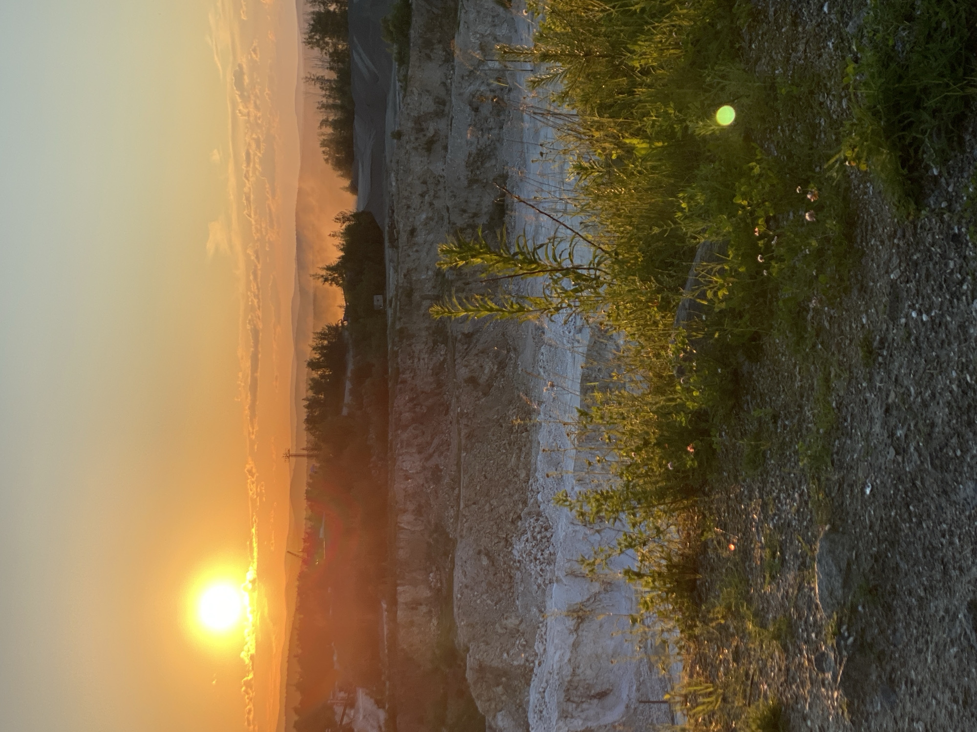Sunset over a Yekaterinburg quarry, rock and wildflowers