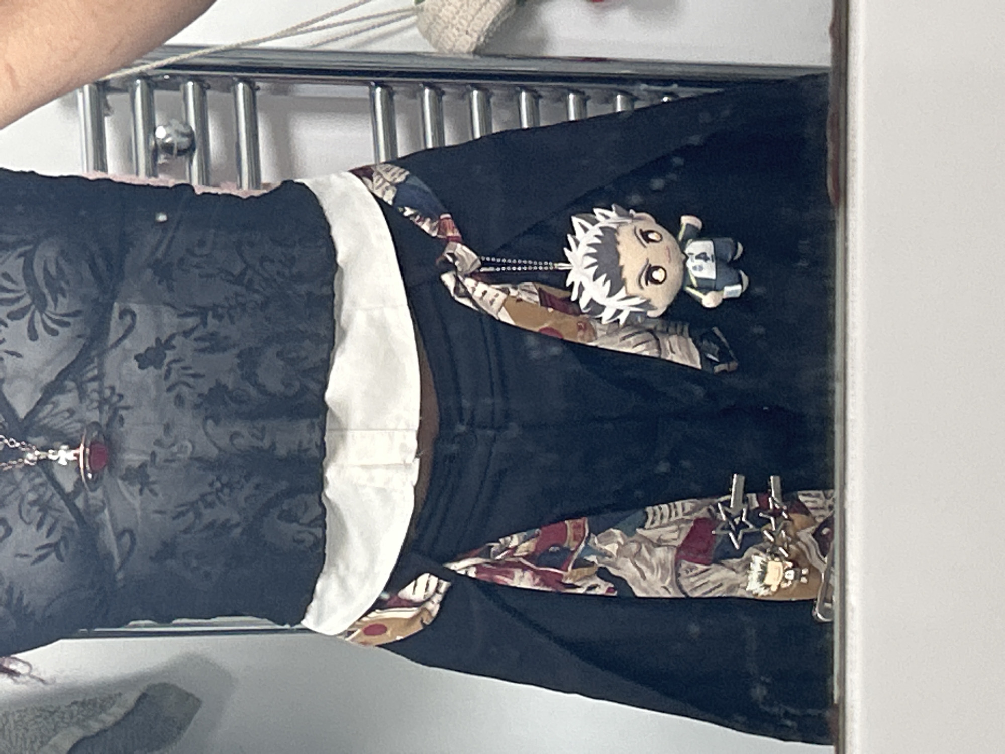 Mirror reflection captures patterned black garment in London