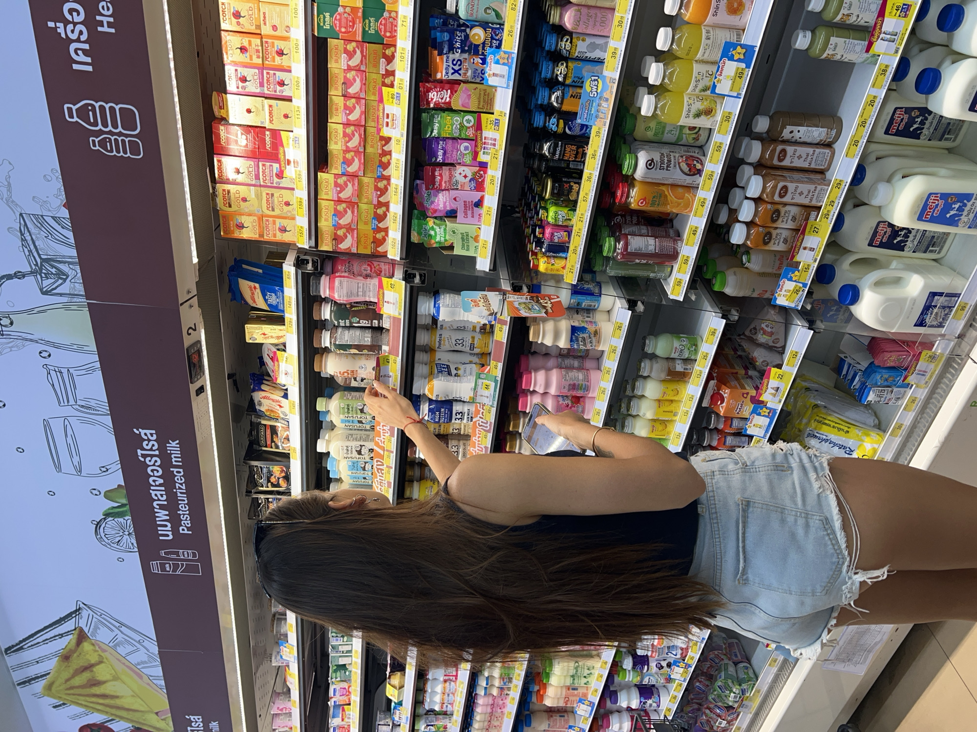 Woman shops at convenience store in Baan Lipa Noi