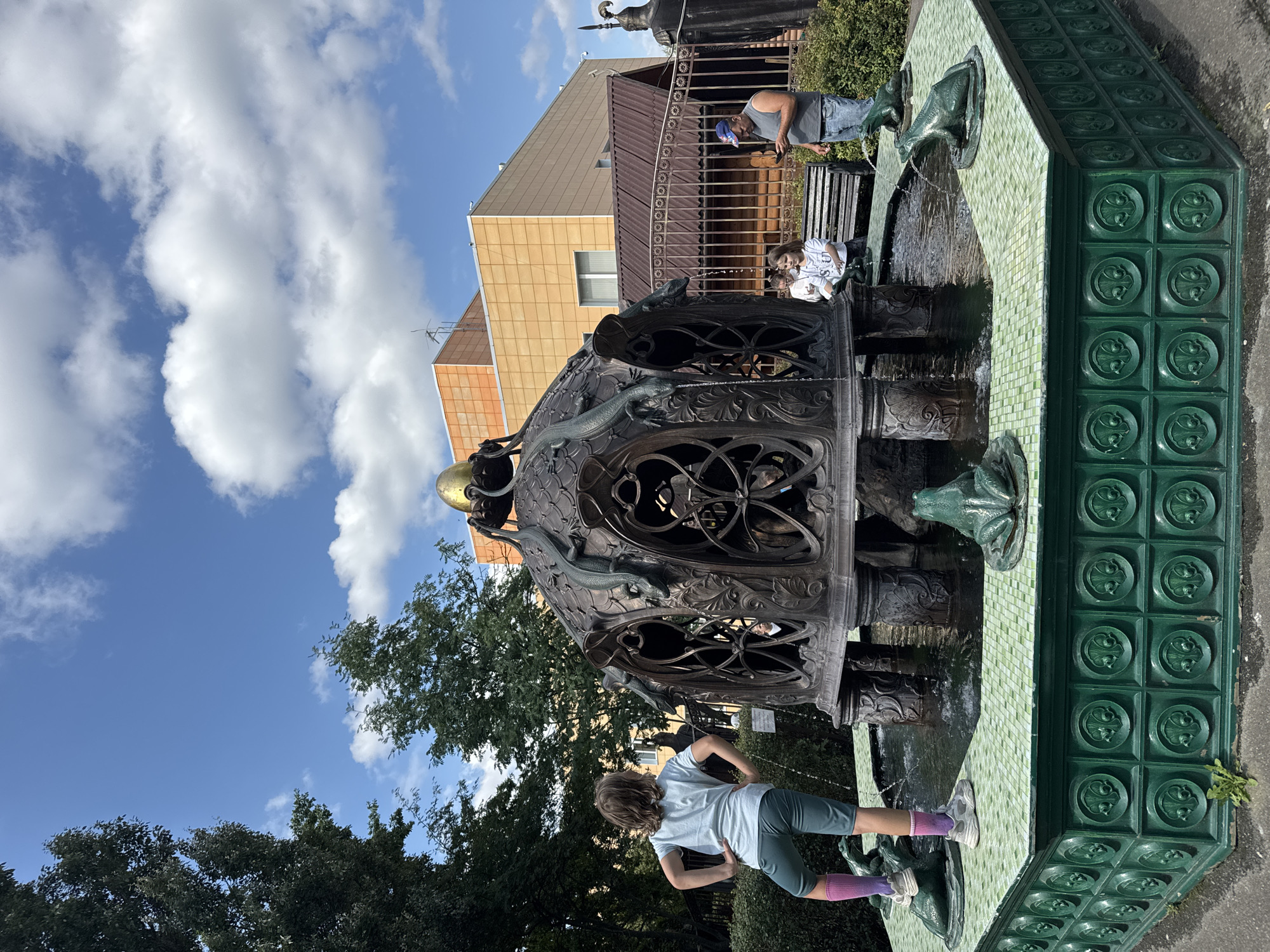 Bronze fountain and chain-wrapped oak tree at Sovkhoza imeni Lenina