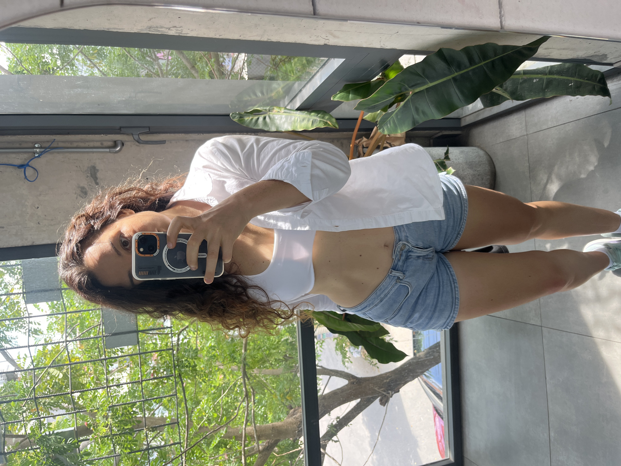 Morning mirror selfies in apartment overlooking Vietnam greenery