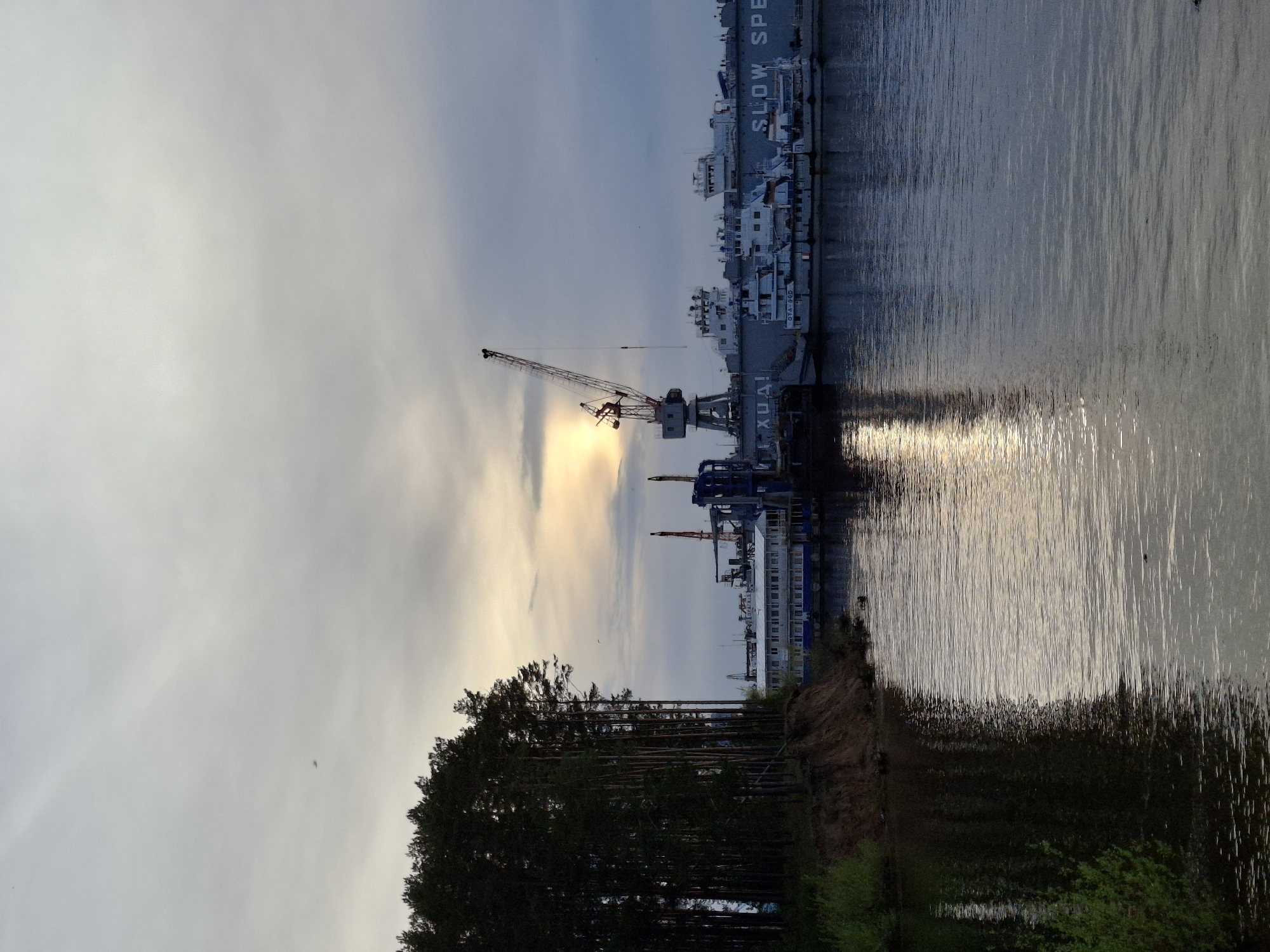 Afternoon waterfront stroll documented in Chaikovsky, Russia industrial port area