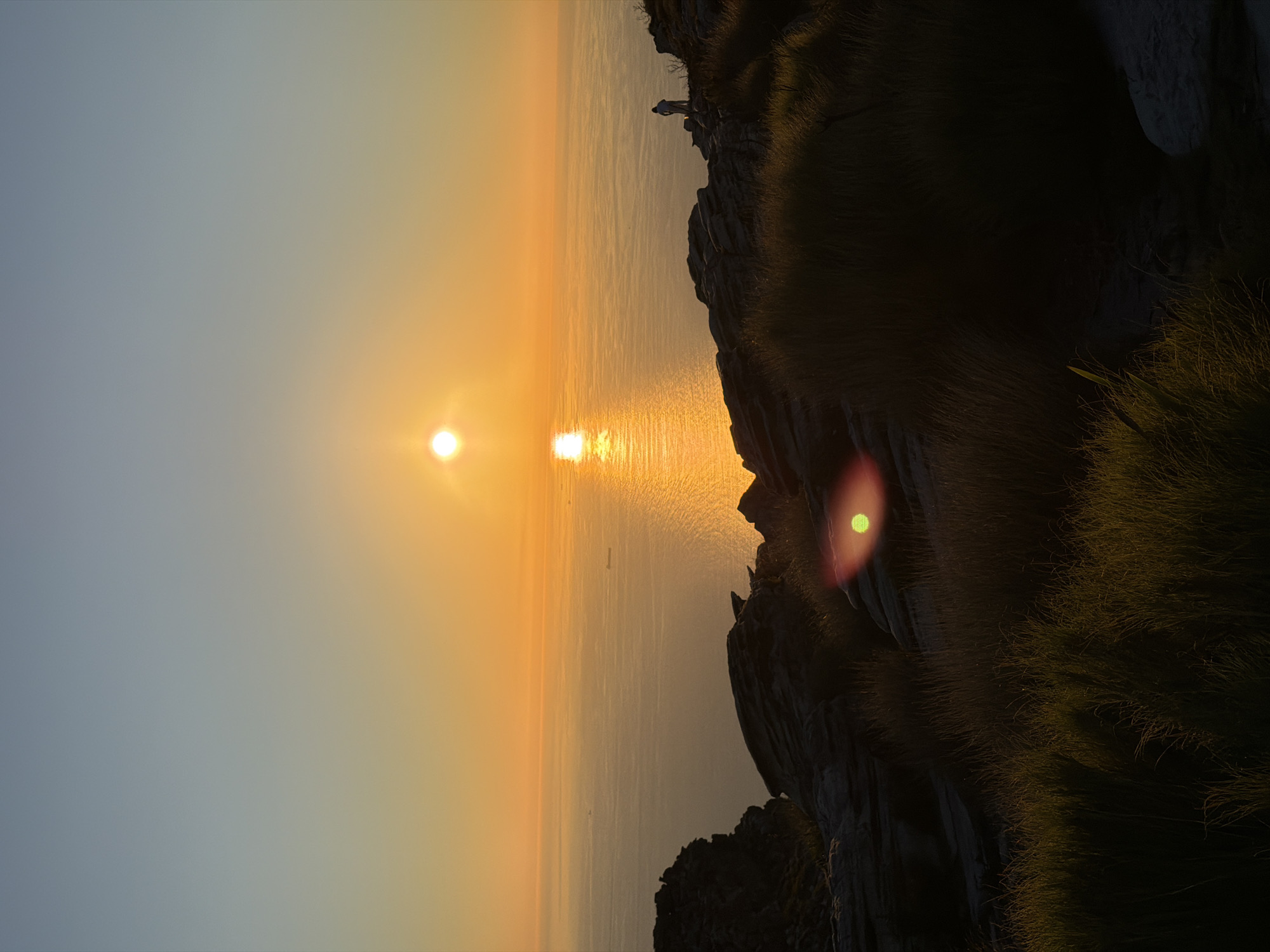 Sunset photographed from Cape Town clifftop overlooking ocean