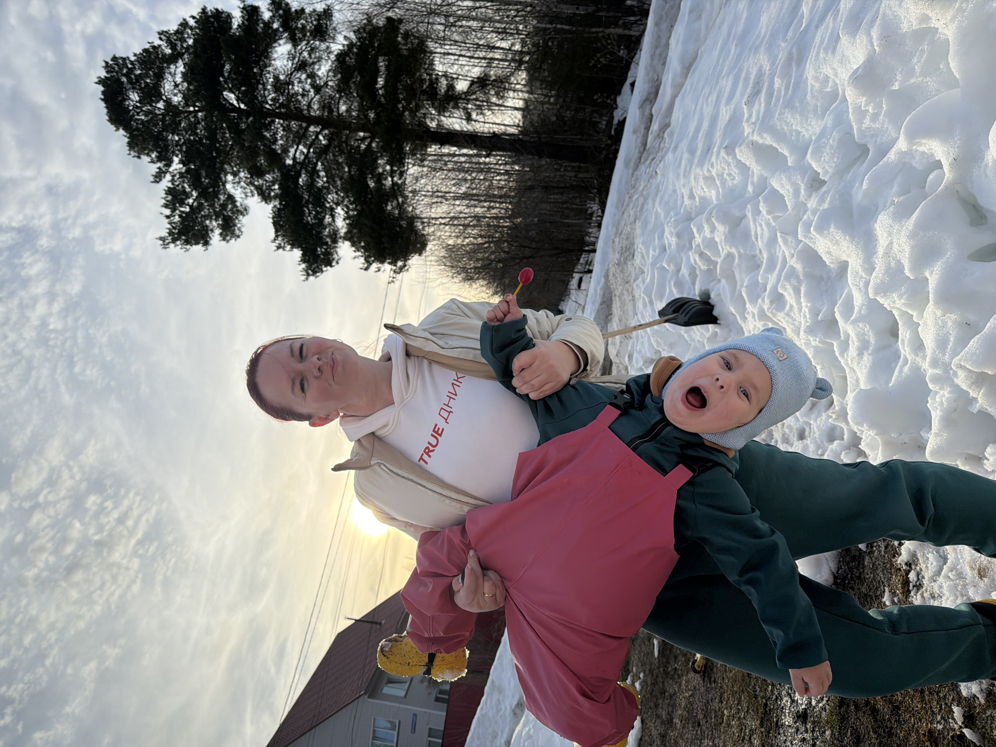 Family day outdoors in snowy Chaikovsky with dog
