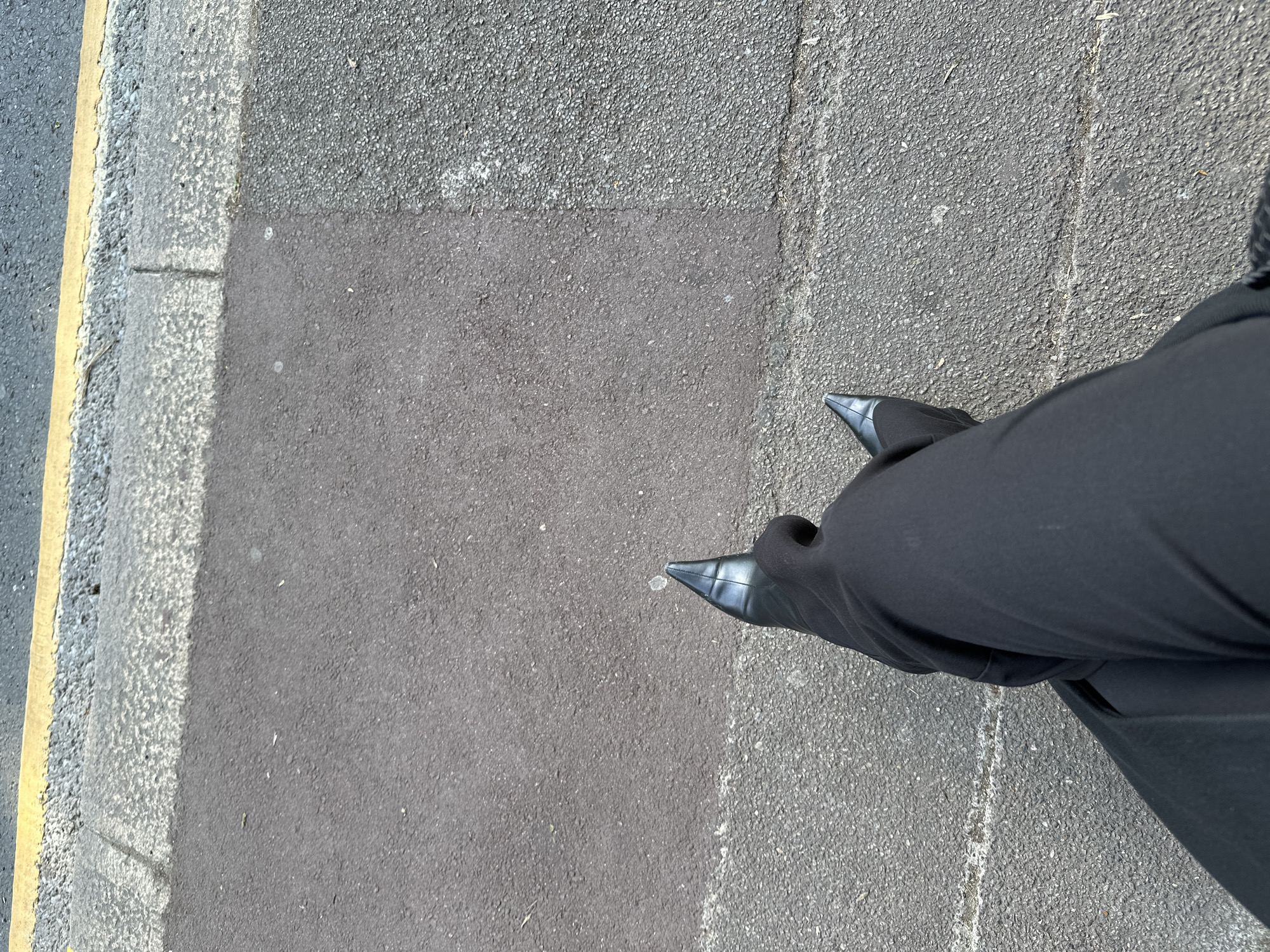 Person in black attire observed standing on London street