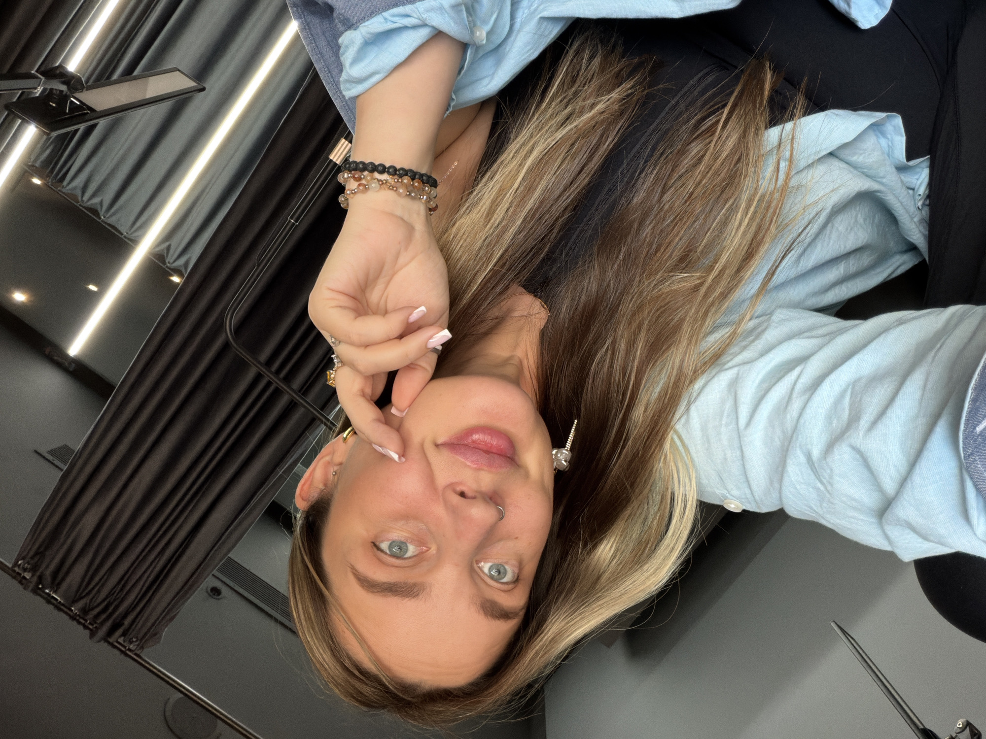 Woman takes selfies in Moscow wearing light blue shirt