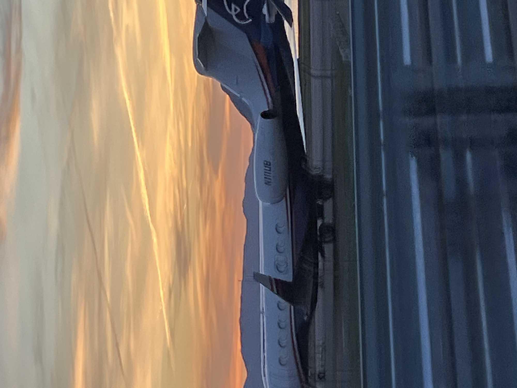 Private jet on tarmac during colorful sunset in Montenegro