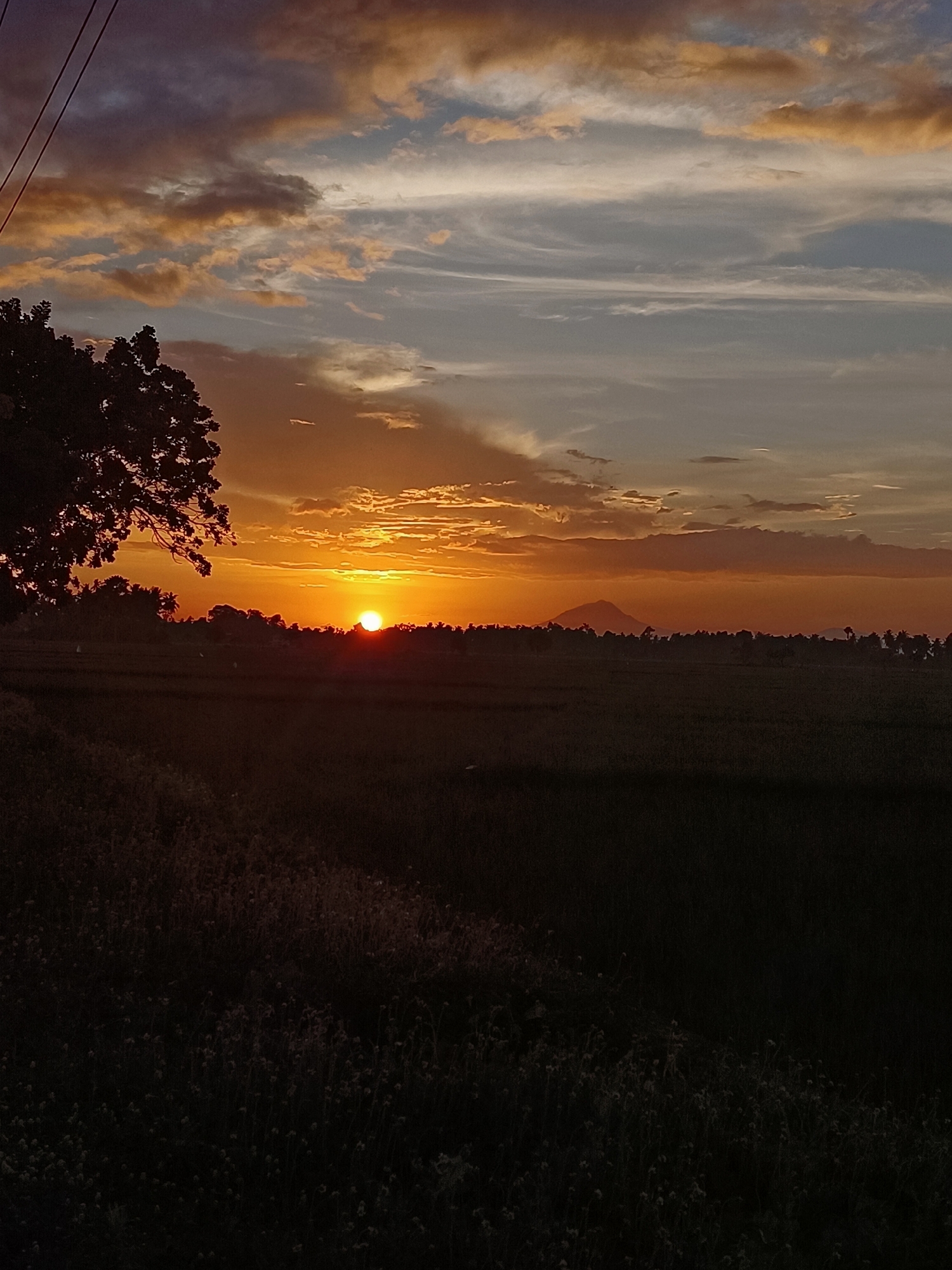 Sunset over the rural ridgeline of Kampung Jumpa, Indonesia
