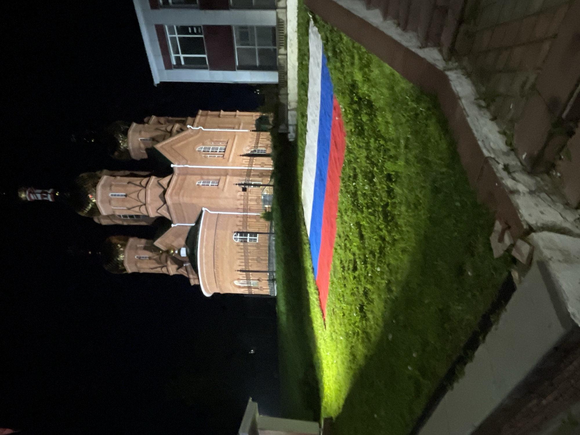Nighttime photos captured in Красные Баки showing church, flowers