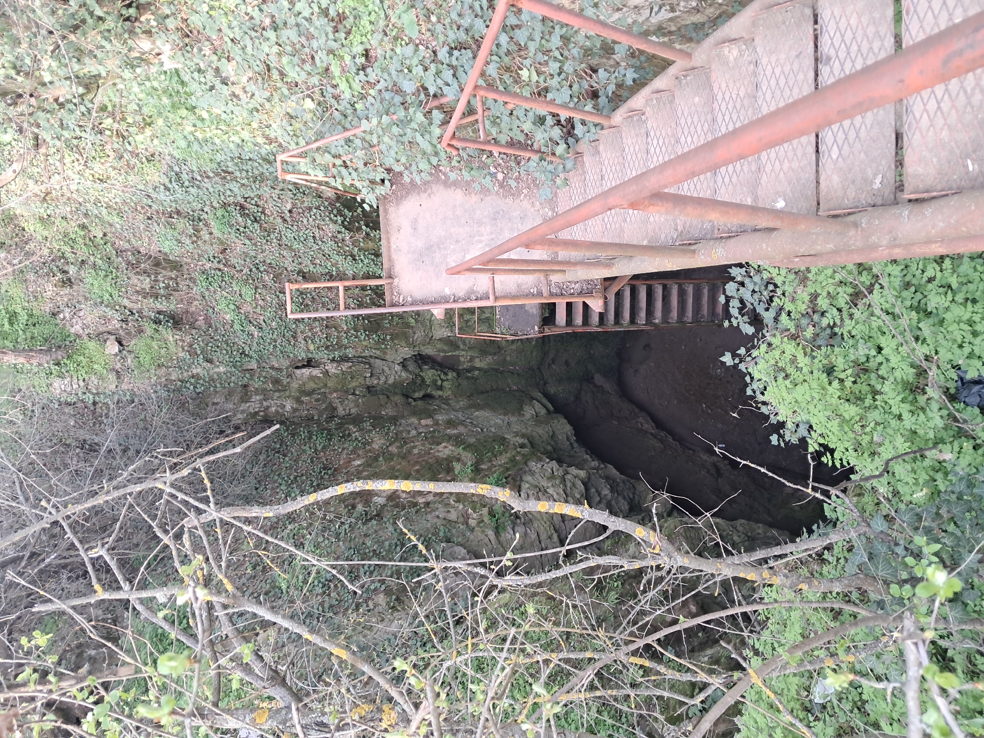 Metal staircase descends into natural chasm in Bulgaria