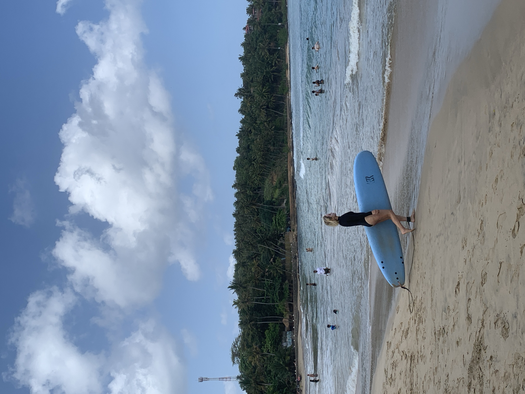 Surfing the clear turquoise break at Hiriketiya Beach