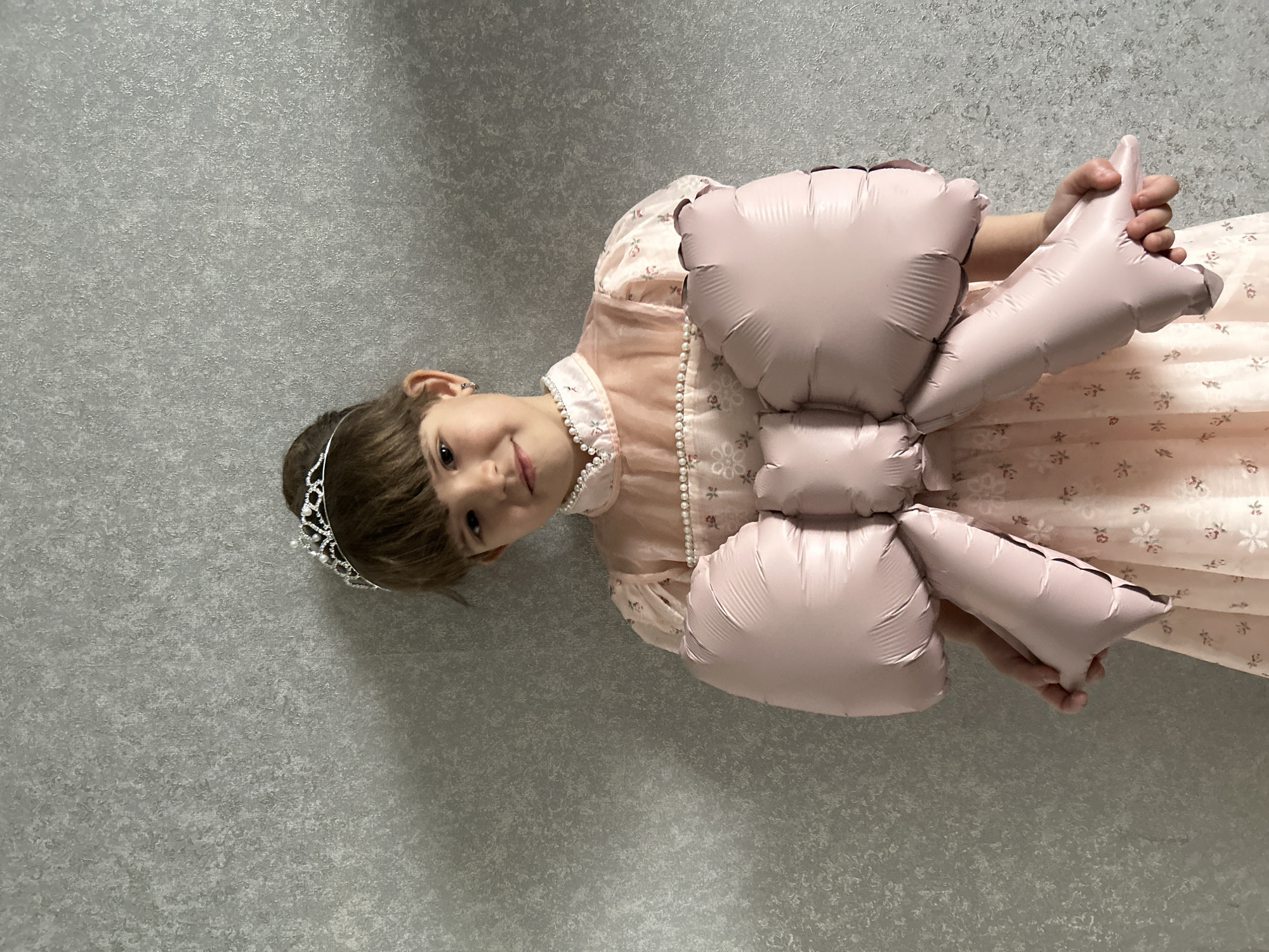 Girl in pink dress draws and plays in Klin