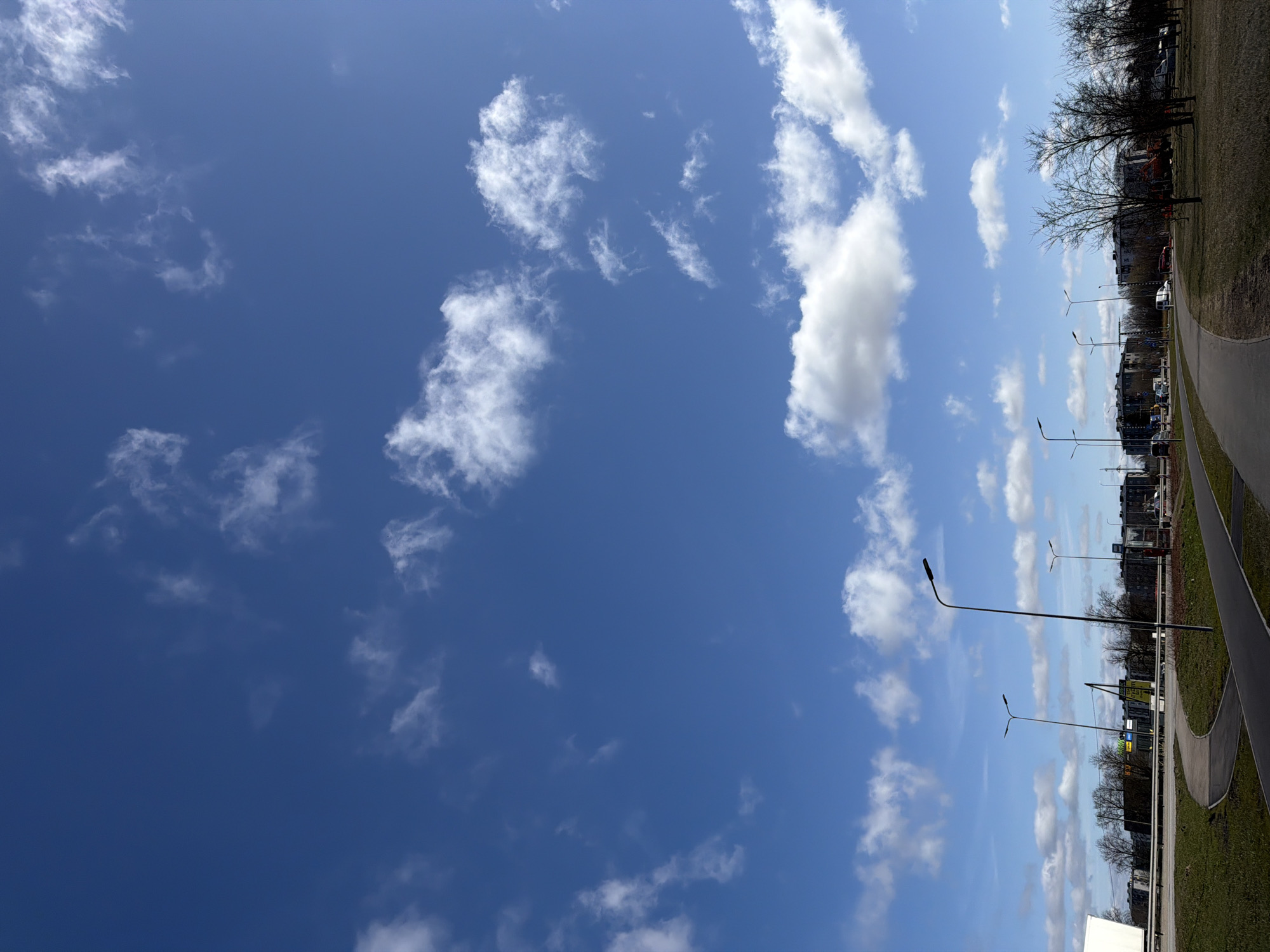 Person spotted looking skyward on sunny morning in Riga