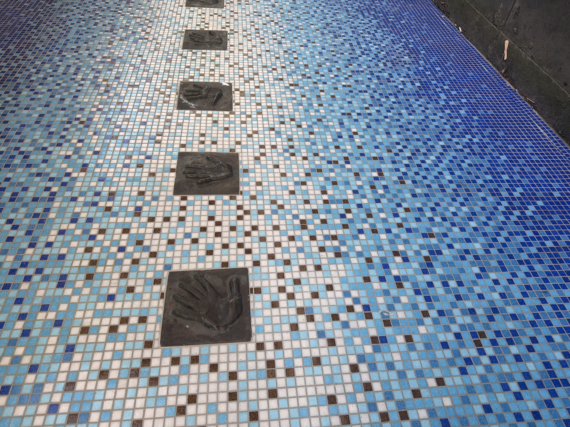 Tiled surfaces with hand plaques observed in Folkestone