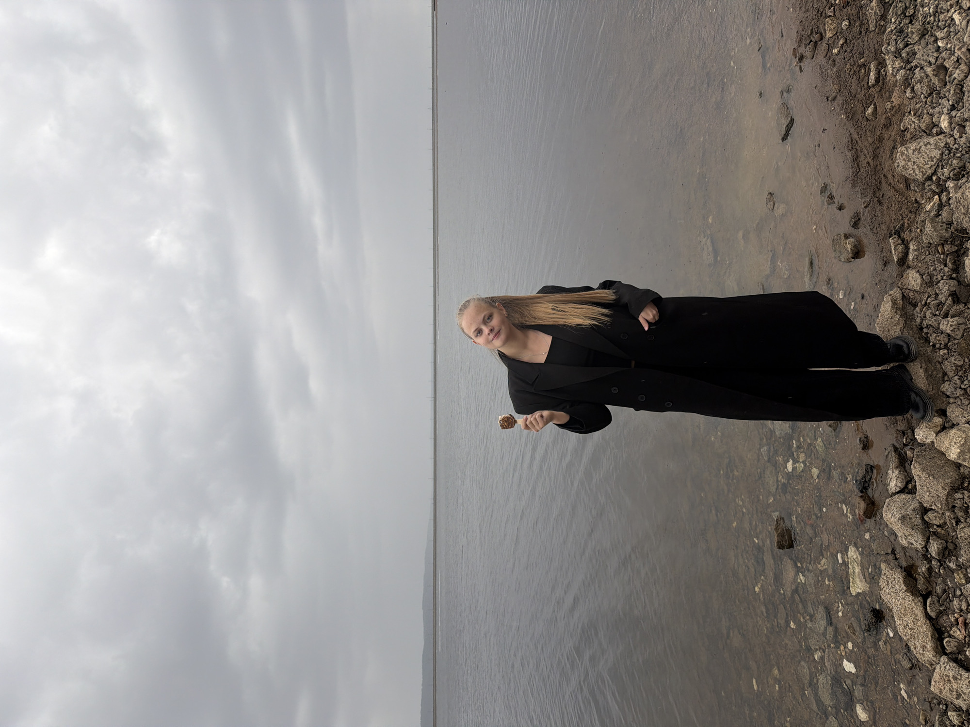 Woman enjoys ice cream by waterfront in Chaikovsky