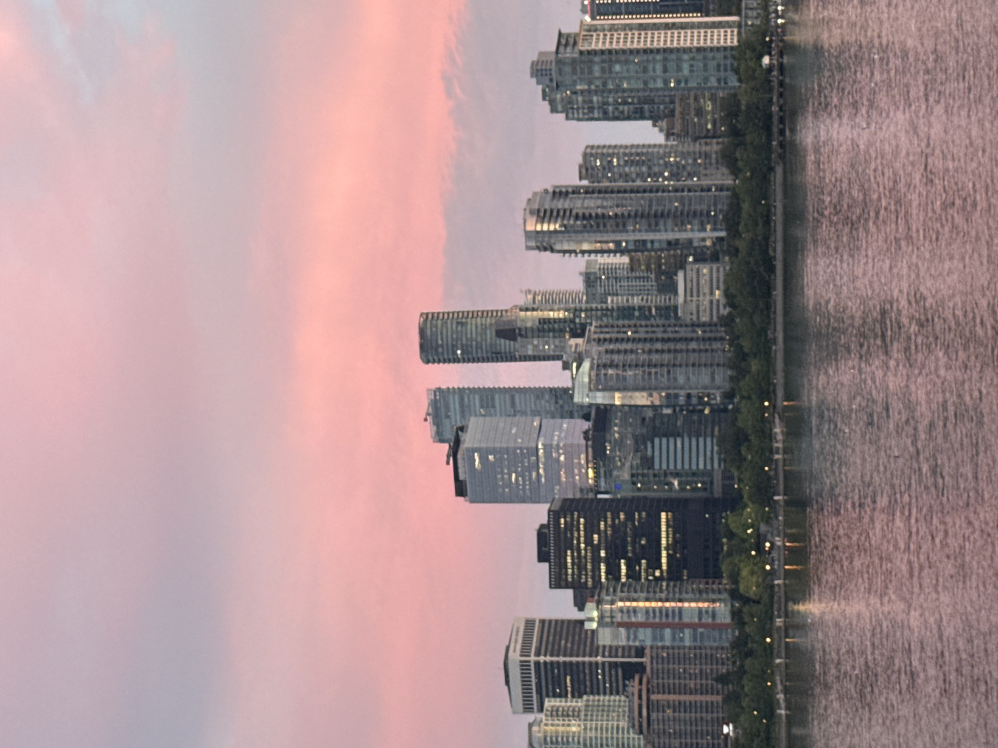 Vancouver skyline glows at dusk in panoramic view