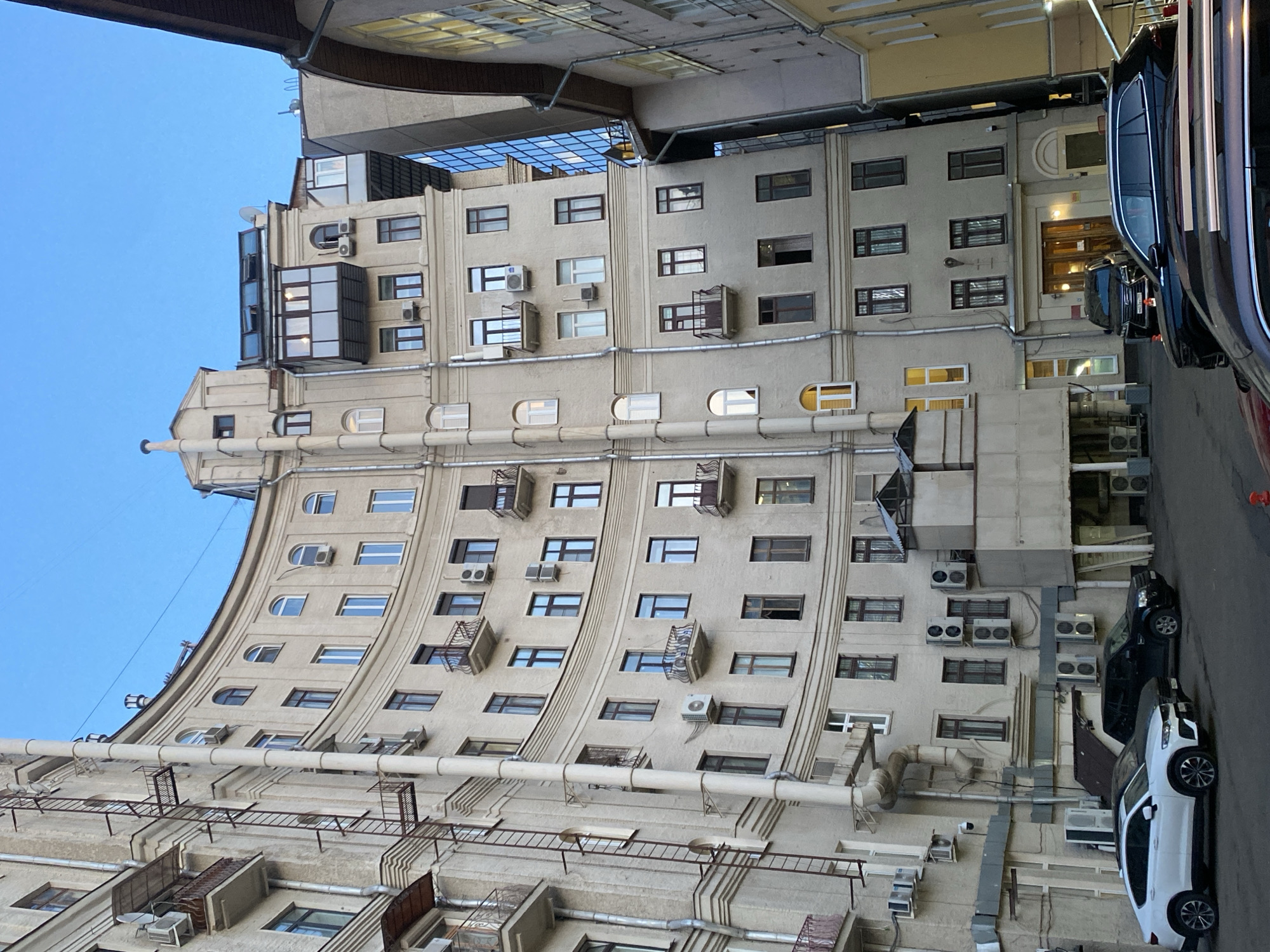 Curved Moscow building with air conditioning units documented