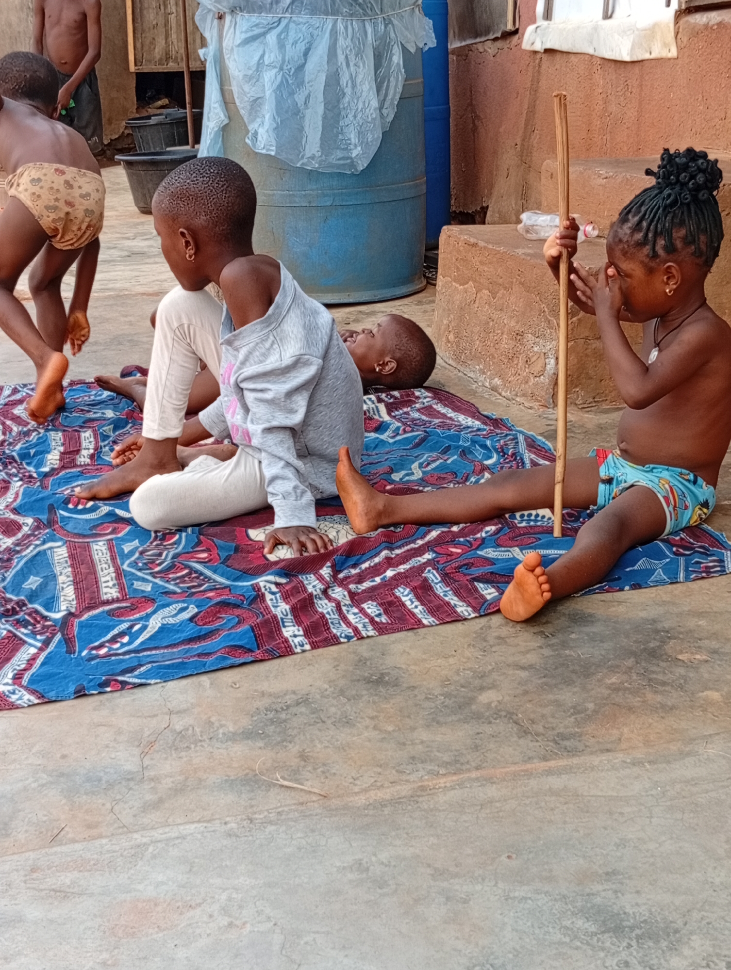 Children play in residential yard in Ogidi, Nigeria