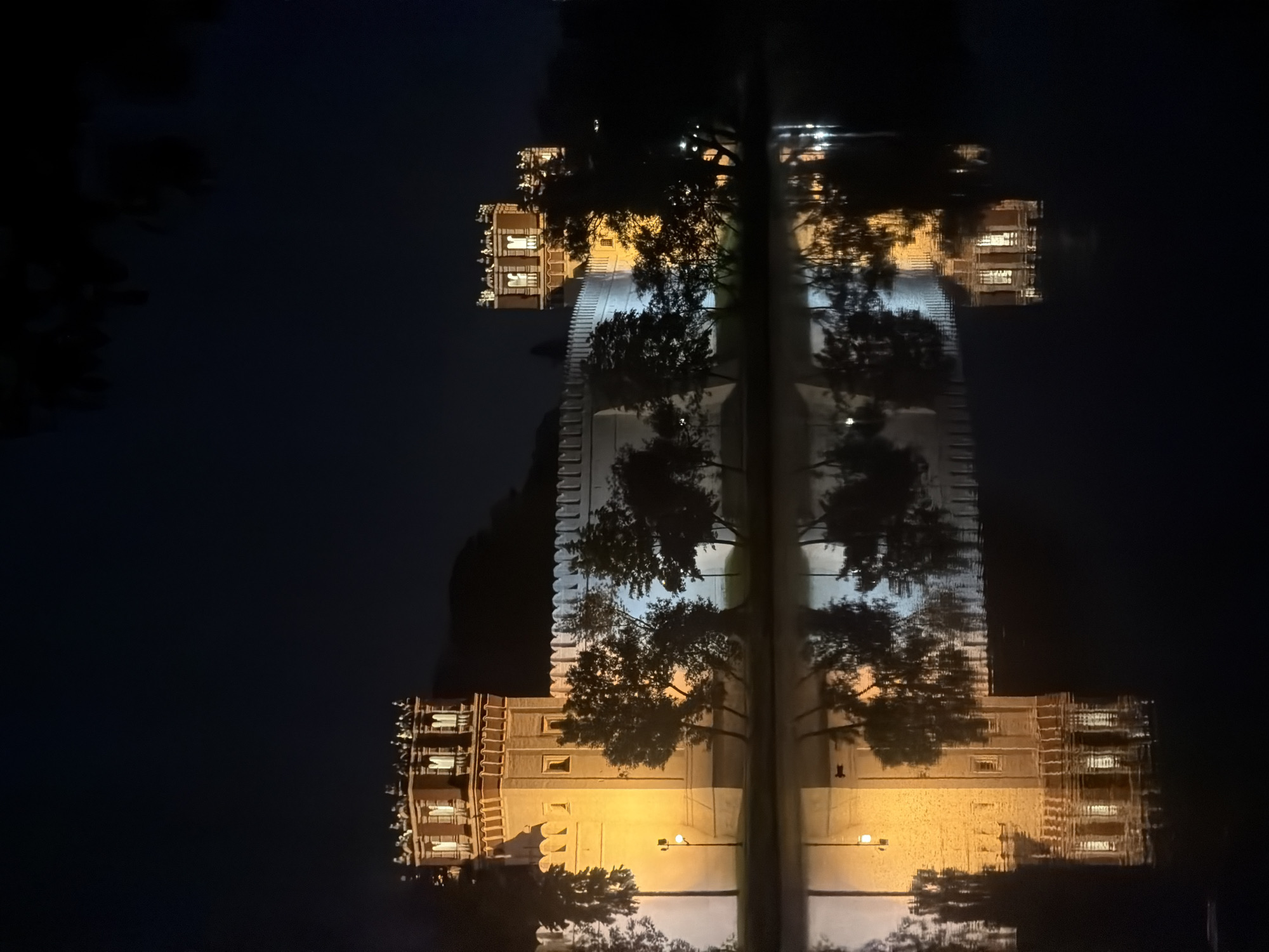 Illuminated Moscow fortress captured in nighttime reflection photograph