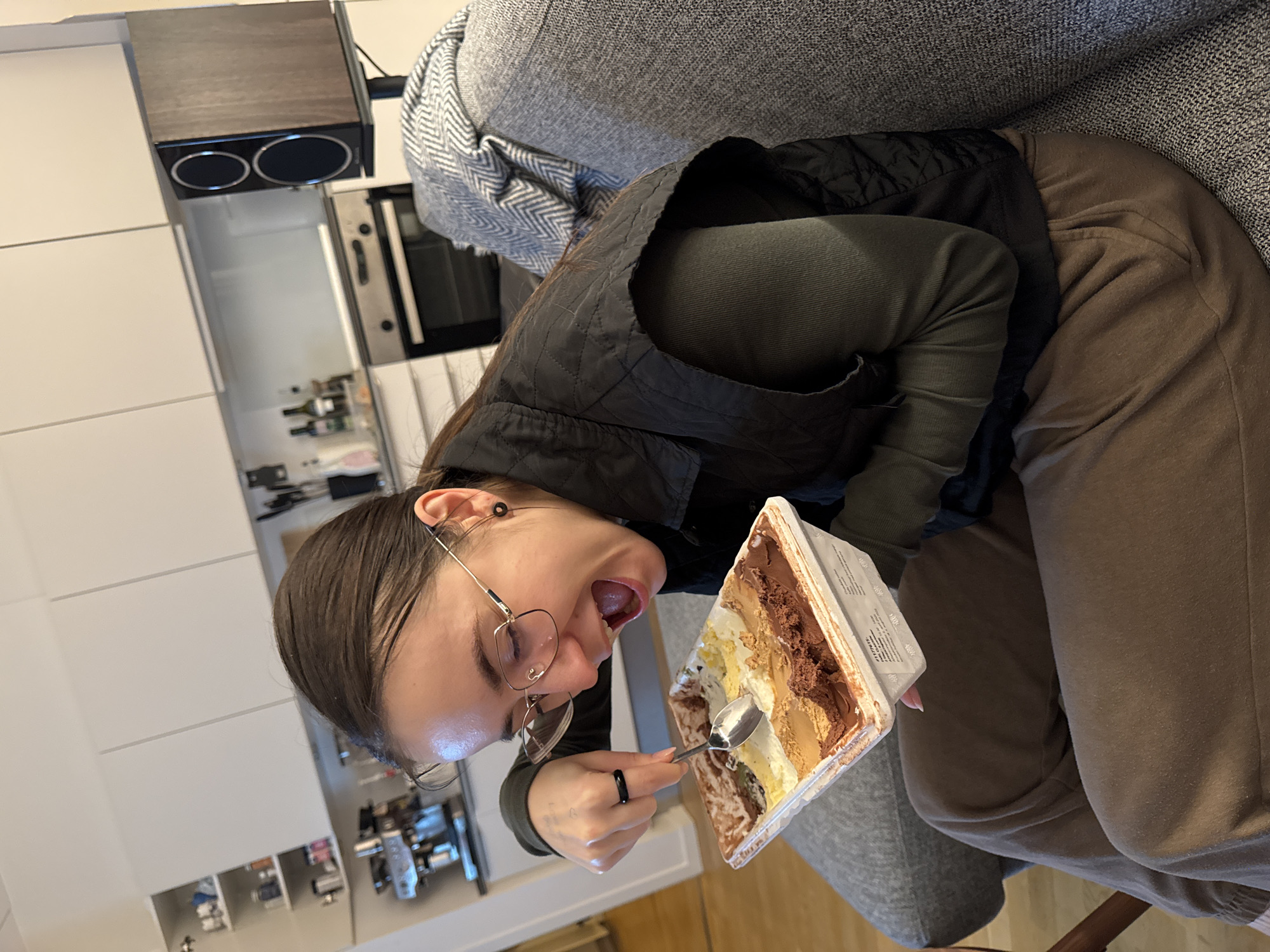 Woman enjoys ice cream on sofa in Copenhagen