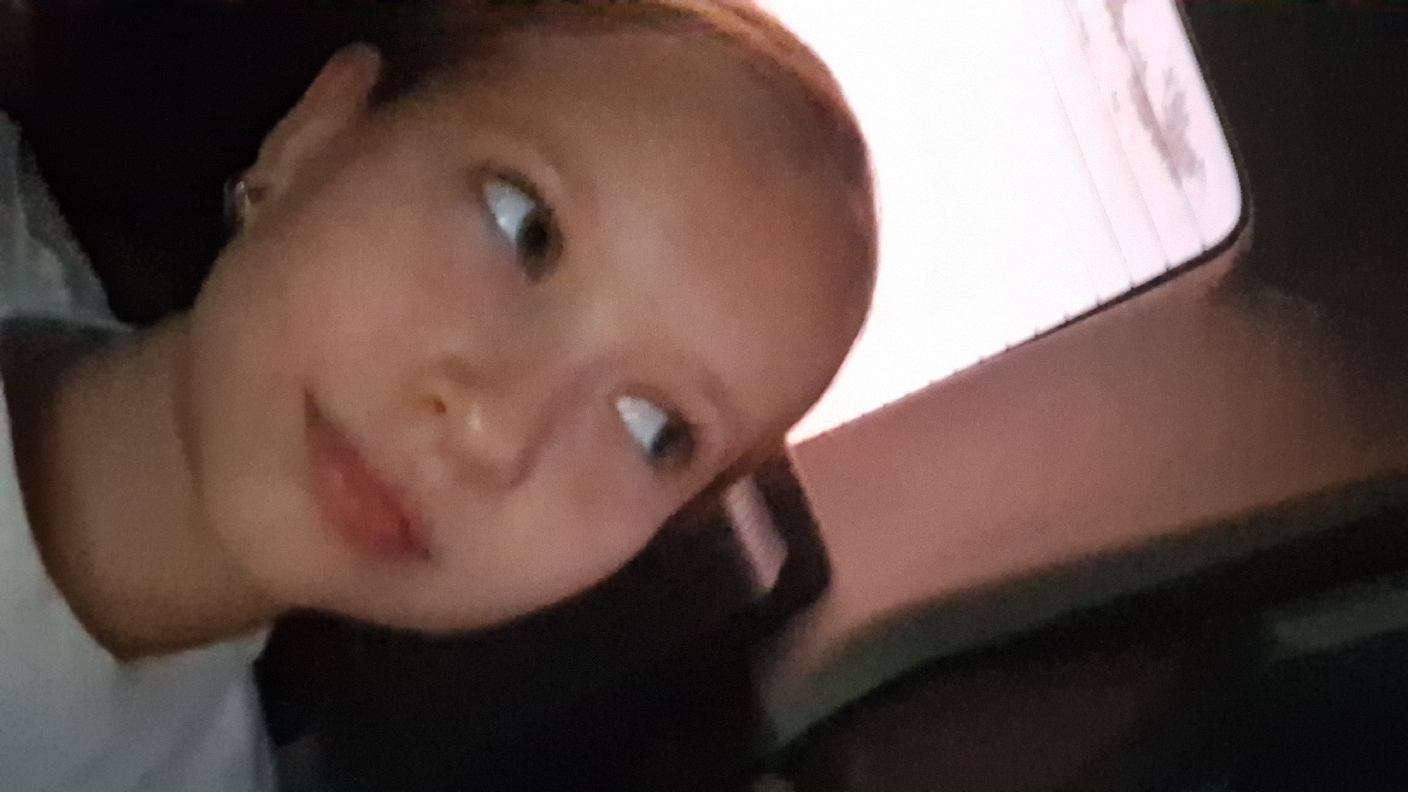 Close-up indoor portraits shot seconds apart in Semey