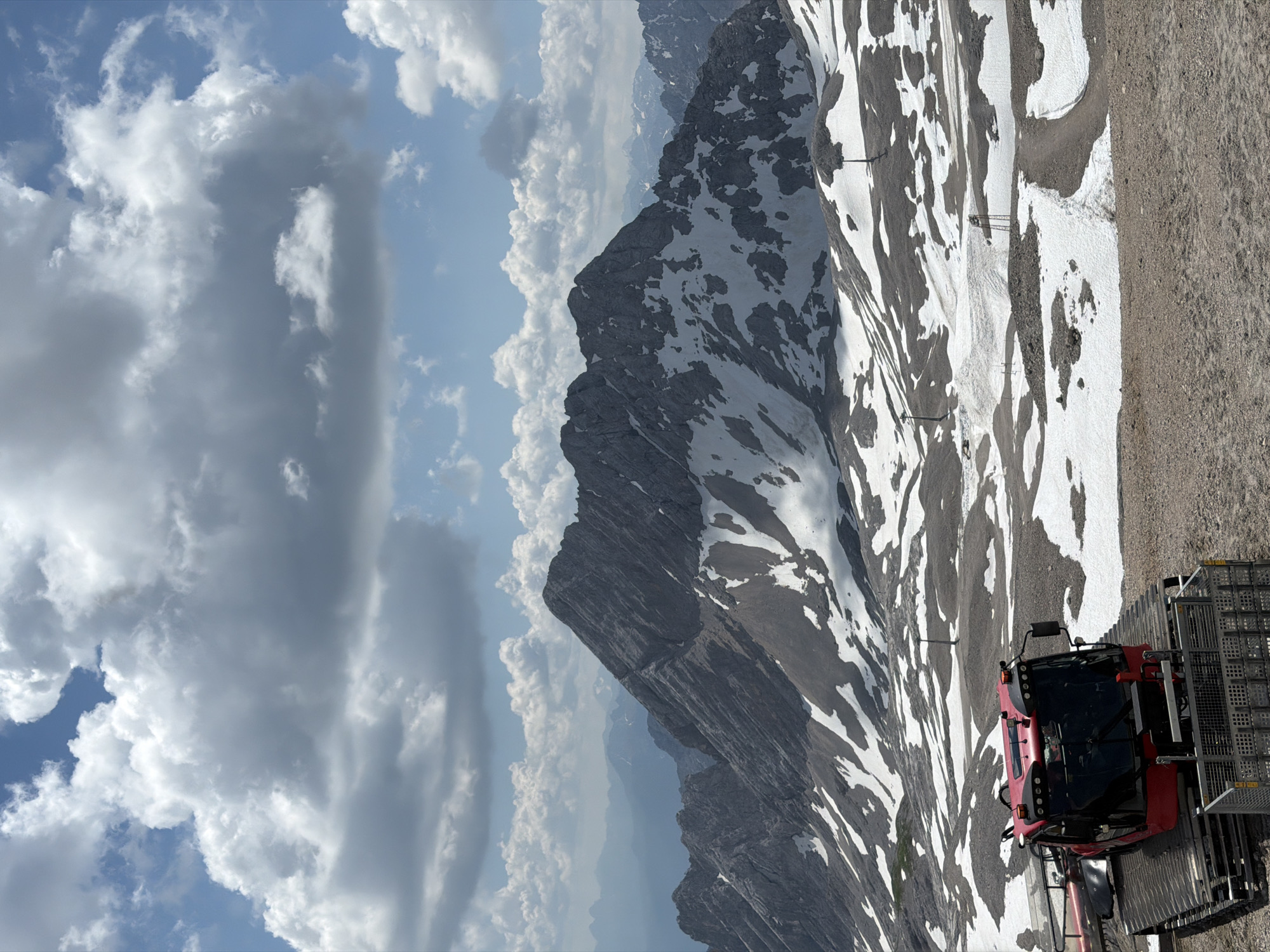 Snow groomer on a late-season slope in the Bavarian Alps