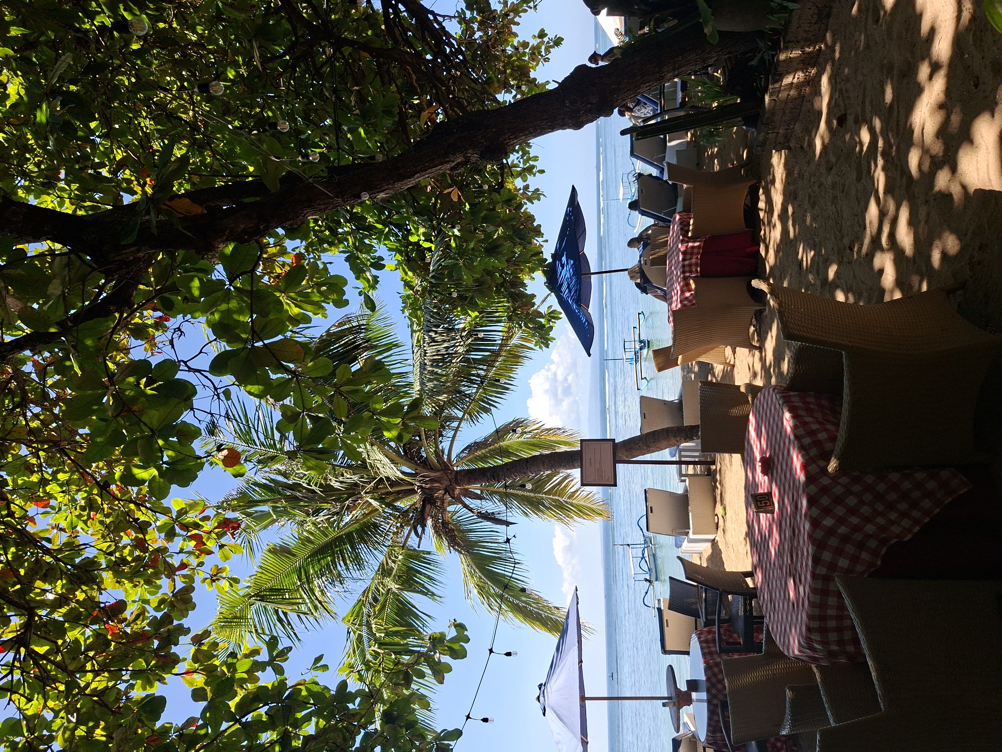 Beachside dining scenes with Buddha sculptures documented in Denpasar